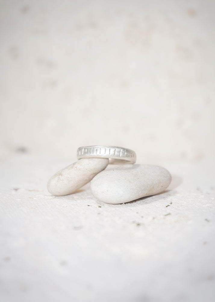 Silver ring laying in a rock