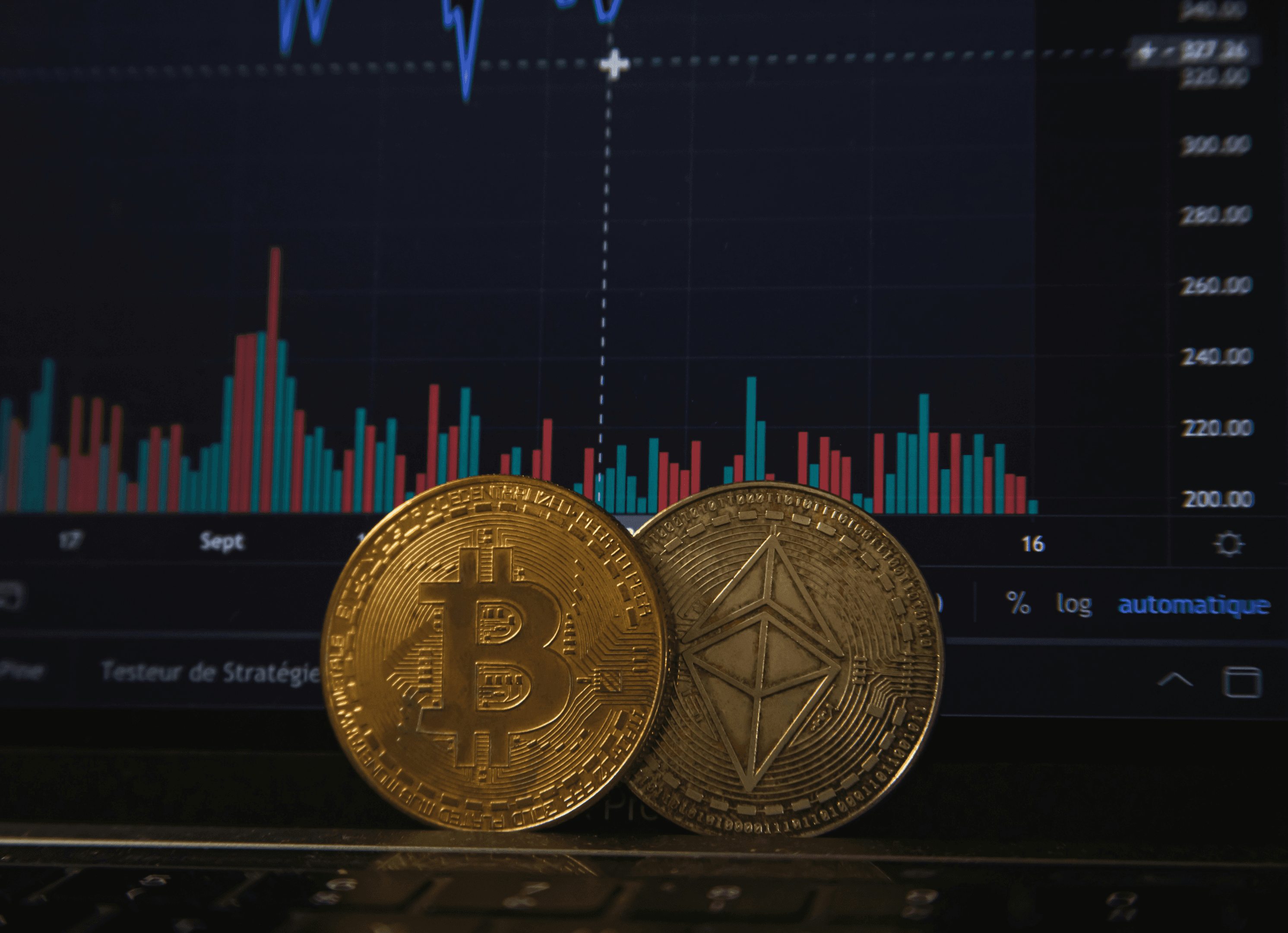 Bitcoins in front of a screen with stats