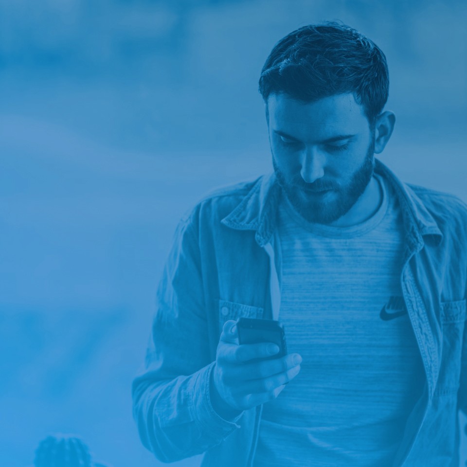 Man holding a phone for the branded mobile provider section