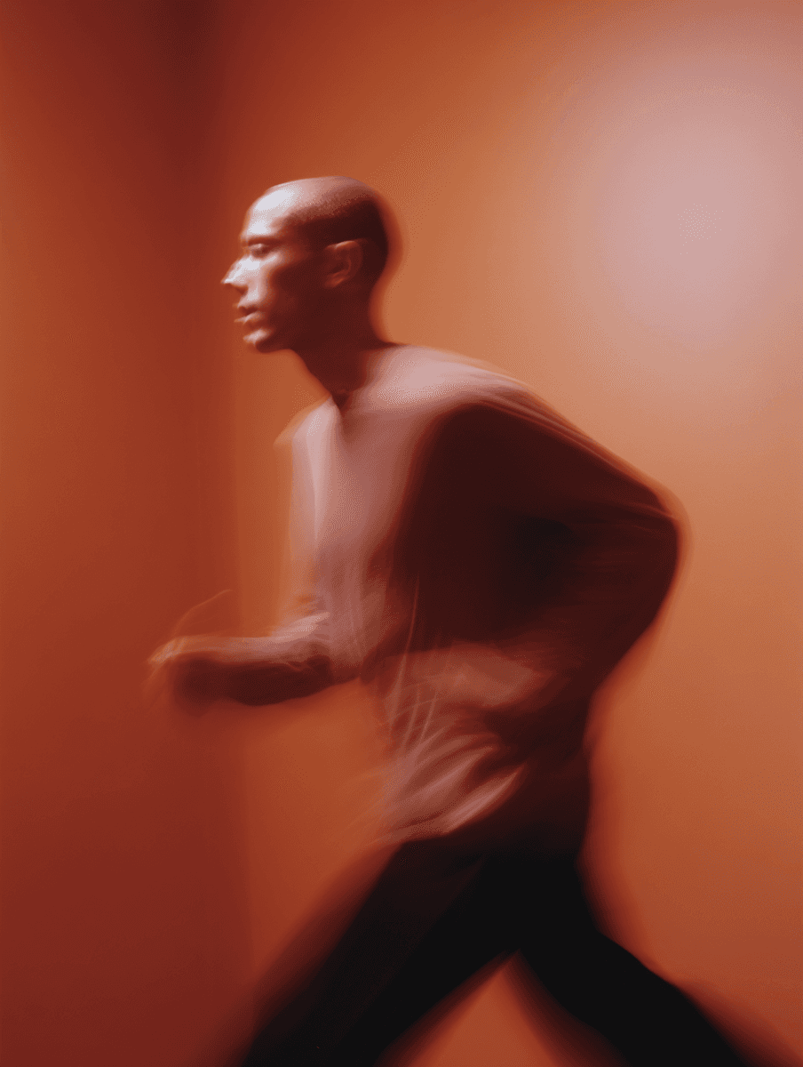 Performer in warm orange light during PRVSM event announcement.