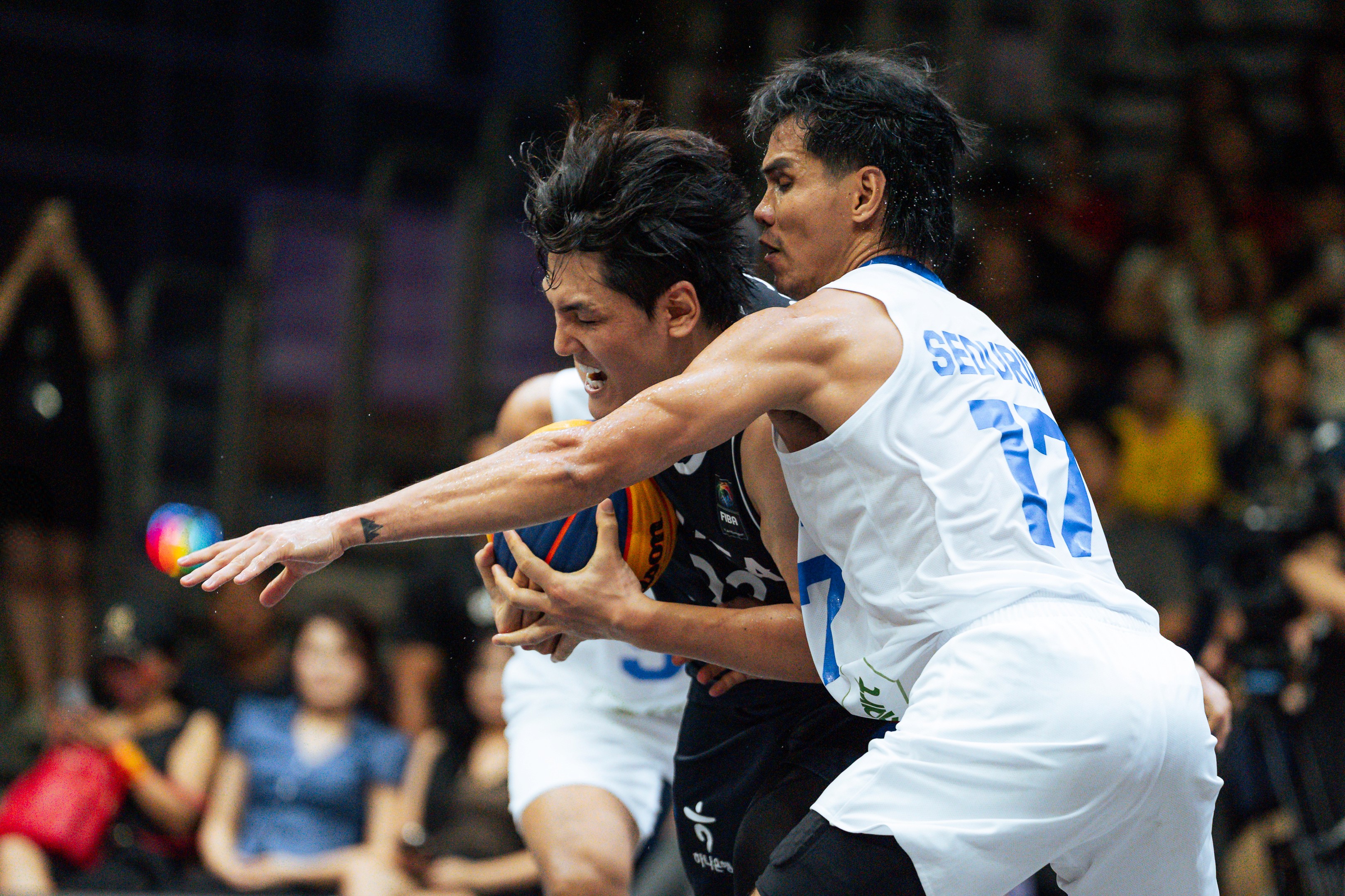 Players challenge for a ball during the FIBA 3x3 tournament in Singapore, 2025
