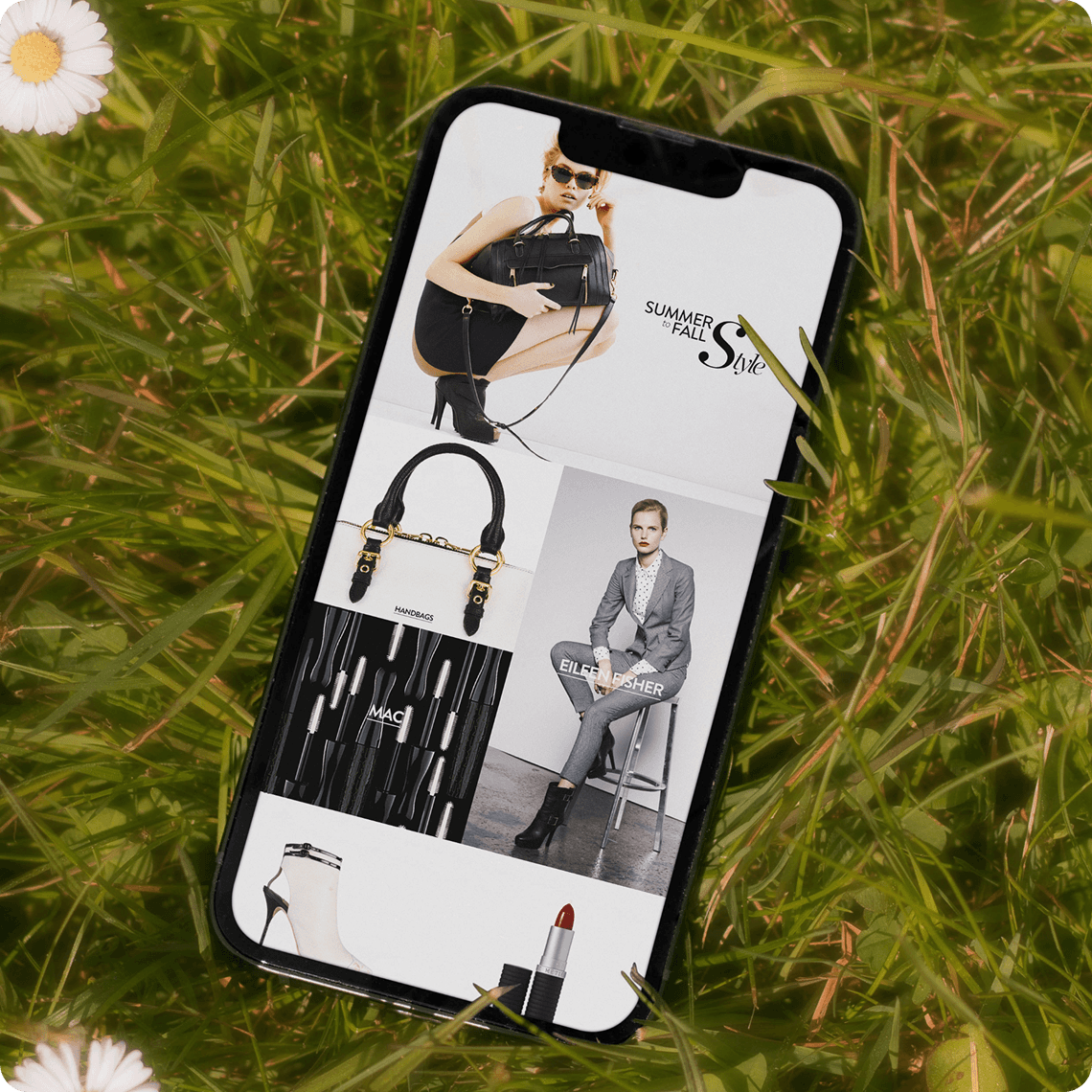 Woman wearing sleeveless black midi dress with white floral print, styled with black oxford shoes against tropical leaves