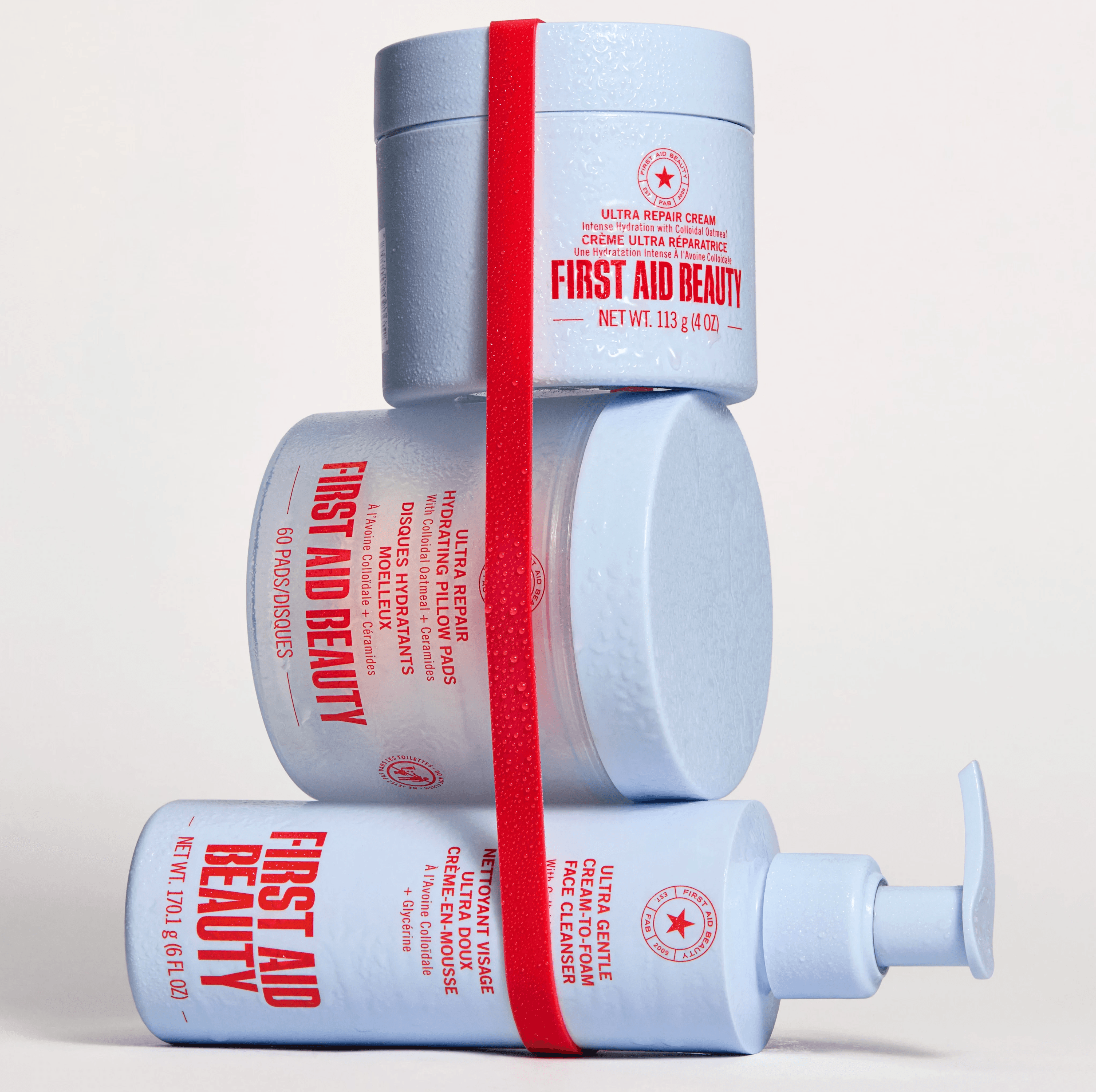 first aid beauty products in a stack with red rubber band.