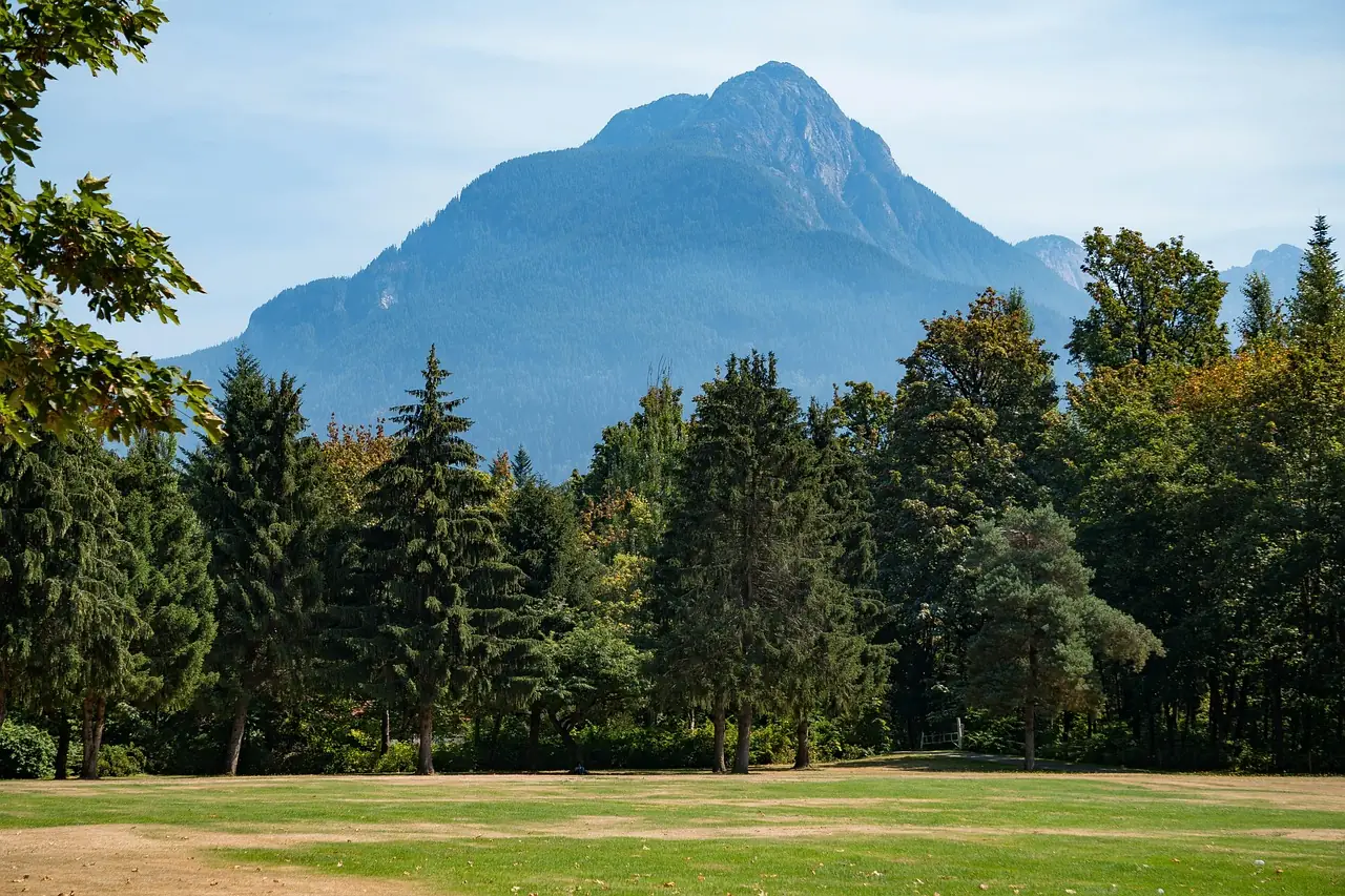 Mountain landscape in Hope, British Columbia, a servicing area for Tenmar; featuring forested evergreens and open park space beneath a prominent peak in the Fraser Valley.