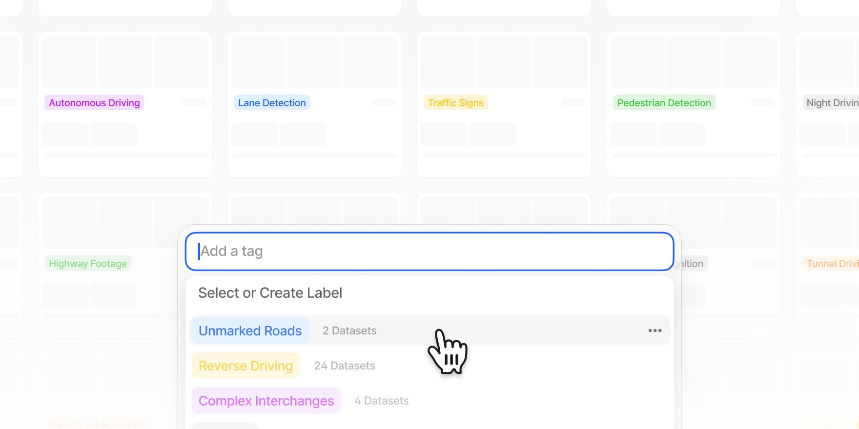 A tagging interface in V7 Darwin with a dropdown to add or select dataset labels. Labels like “Unmarked Roads,” “Reverse Driving,” and “Complex Interchanges” are shown, with a cursor hovering over one of them.