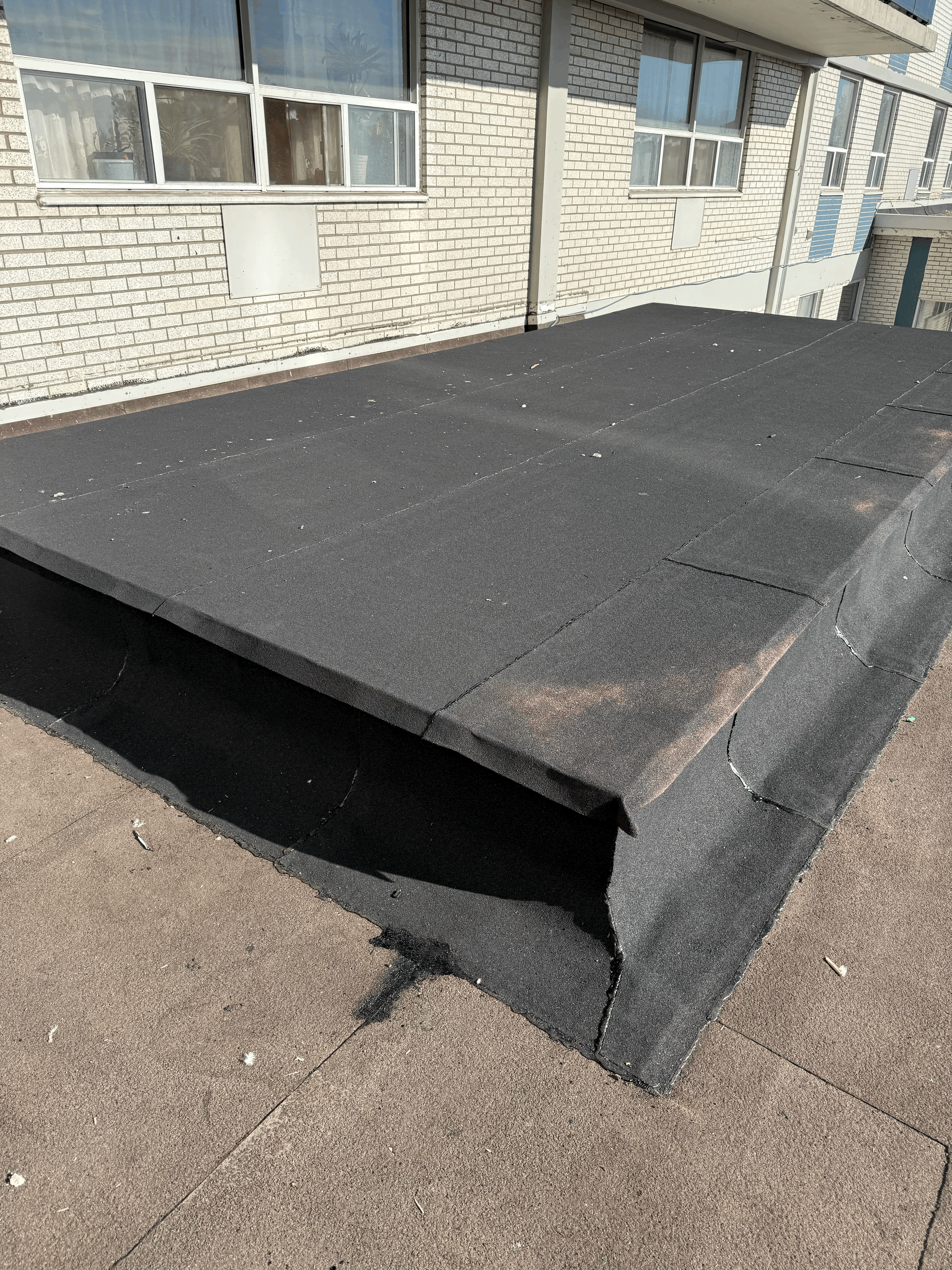 Scarborough flat roof replacement example featuring new roofing membrane installation on a residential home