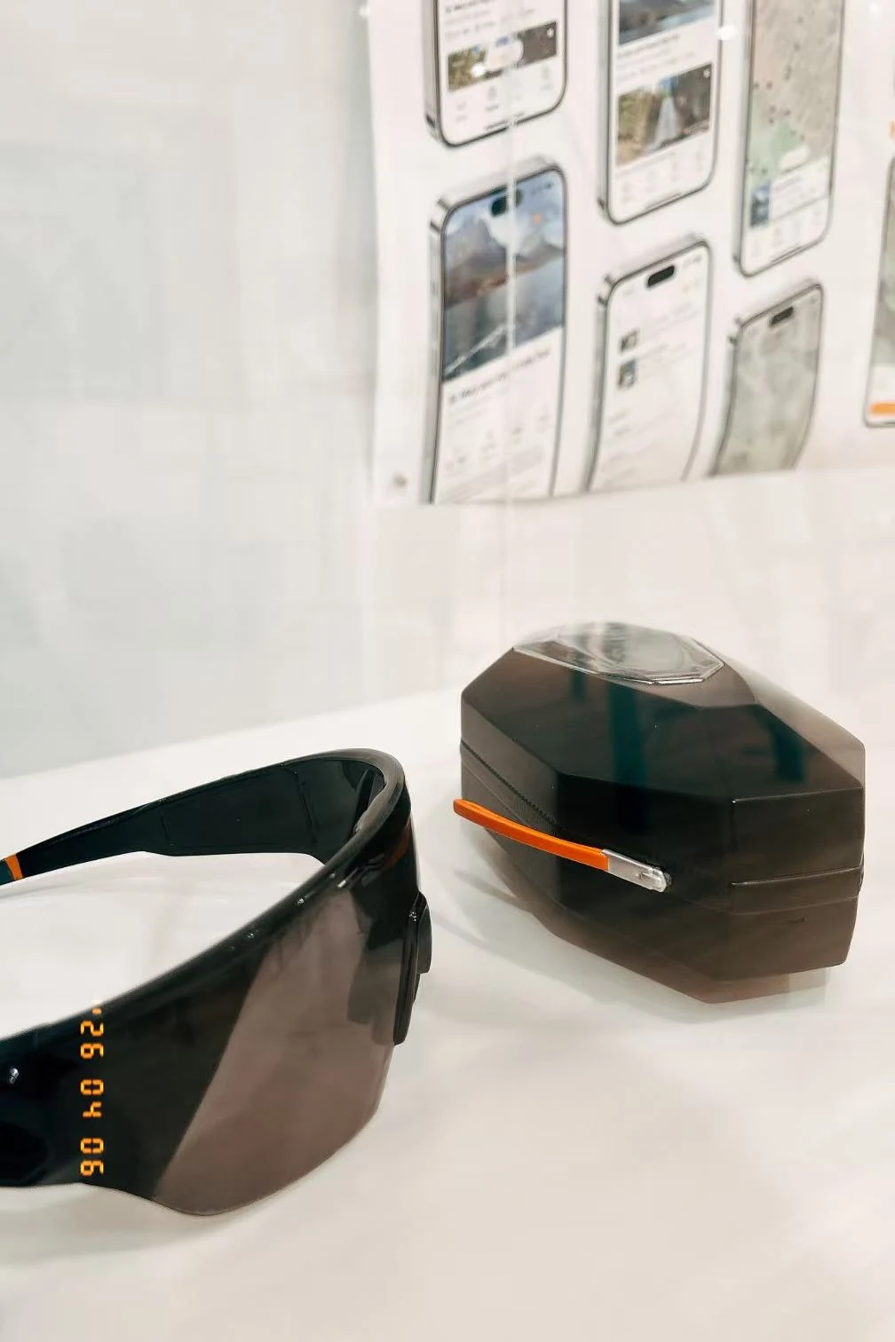 Cairn glasses and charging dock displayed as physical exhibition models.