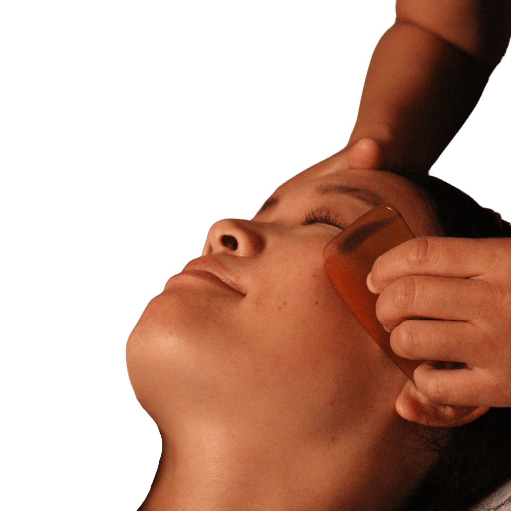 Gua Sha treatment on a patient's face