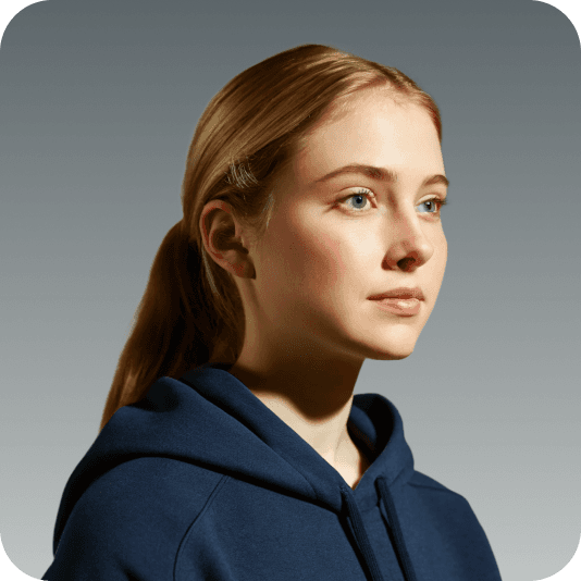 Portrait of a young blonde woman wearing a navy blue hoodie, facing slightly right