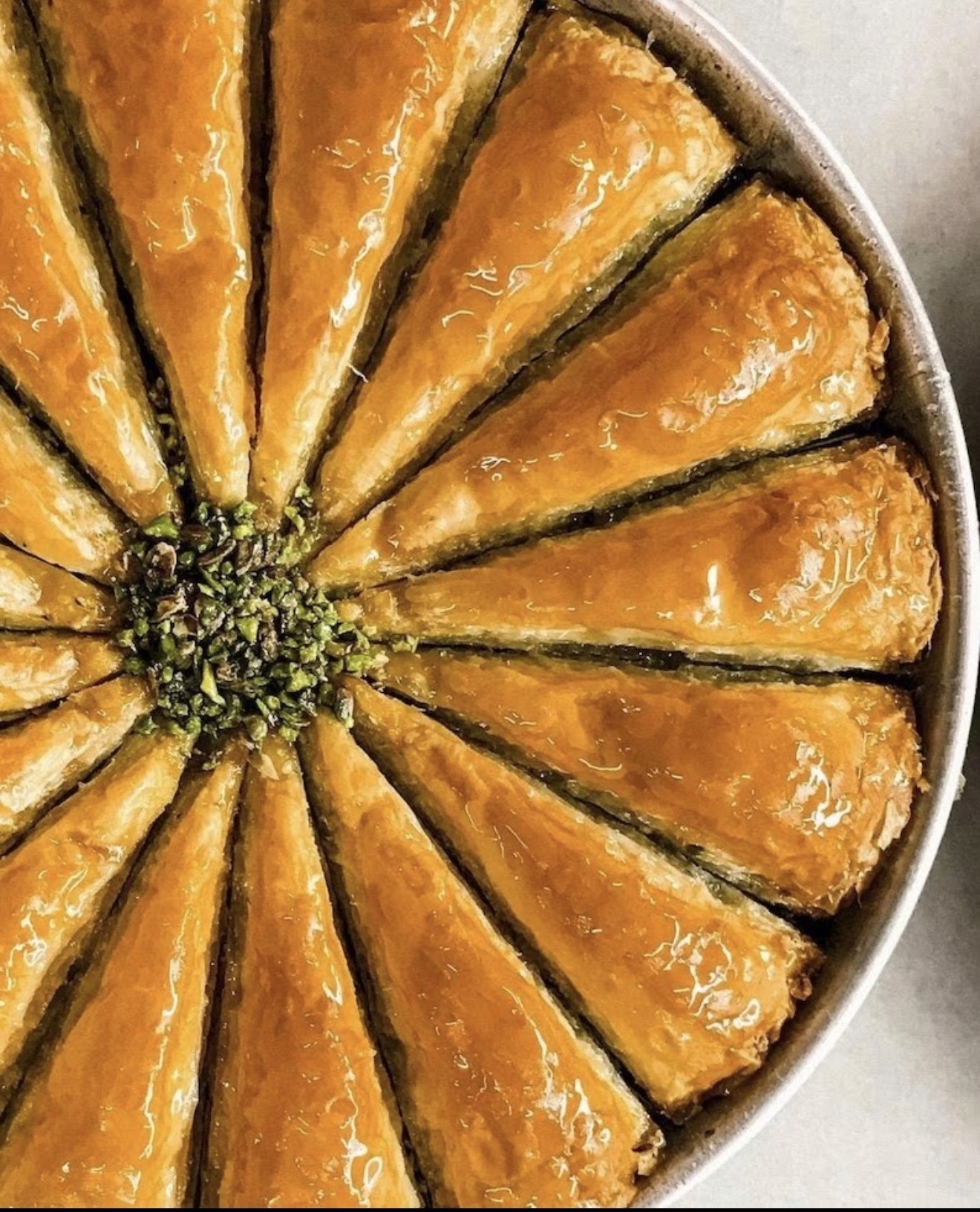 Pistachio baklawa arranged in a round tray