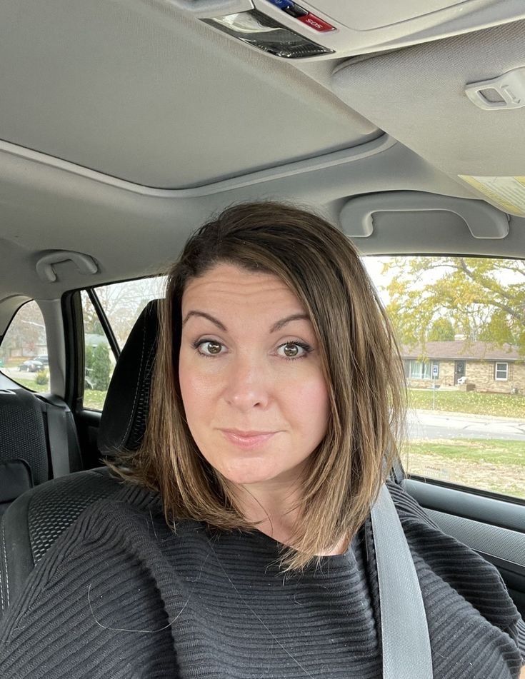 A person in a blacl coat and the brown hairs