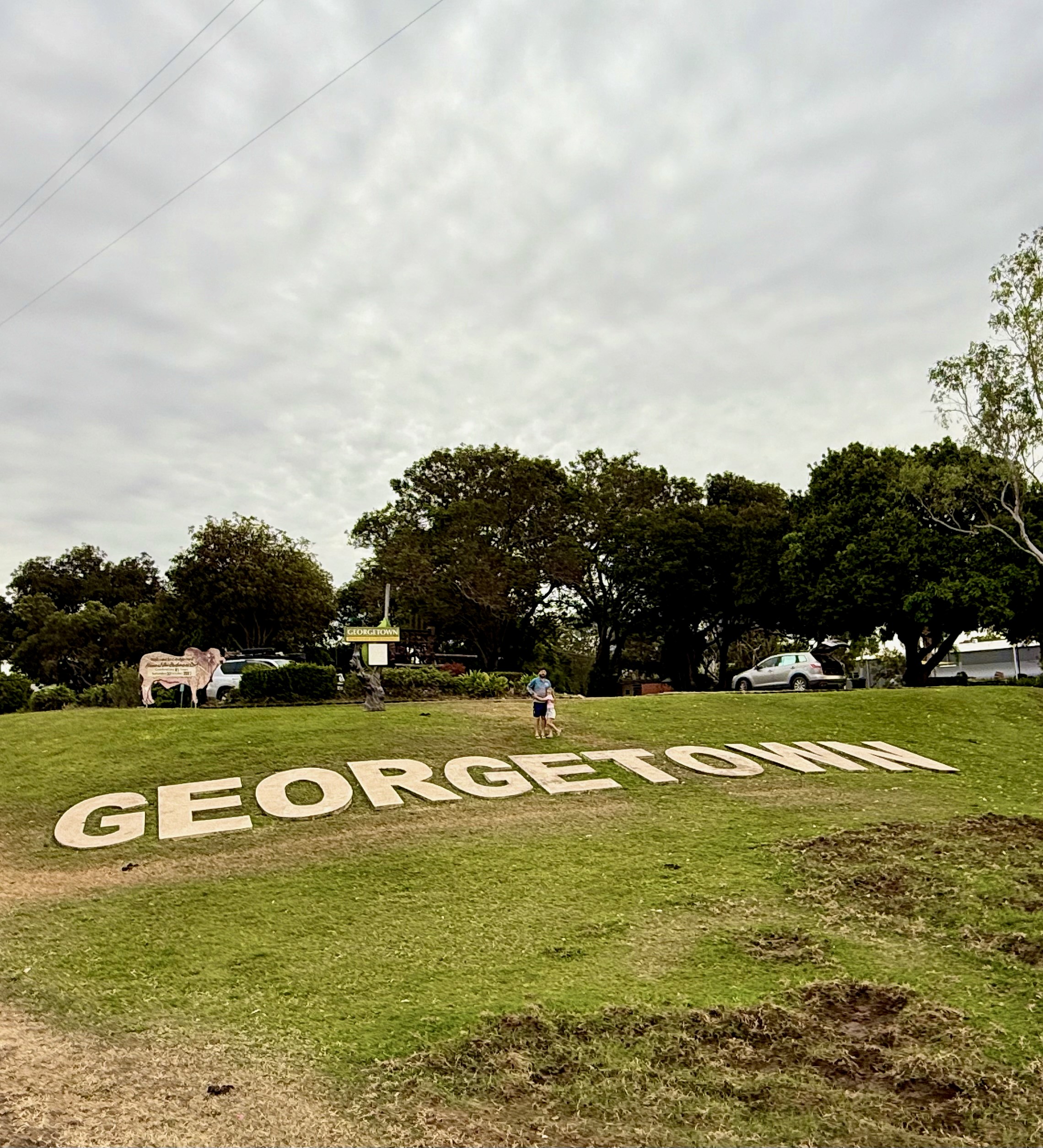 Ross standing by the Georgetown hillside sign, representing local community engagement and rural finance services