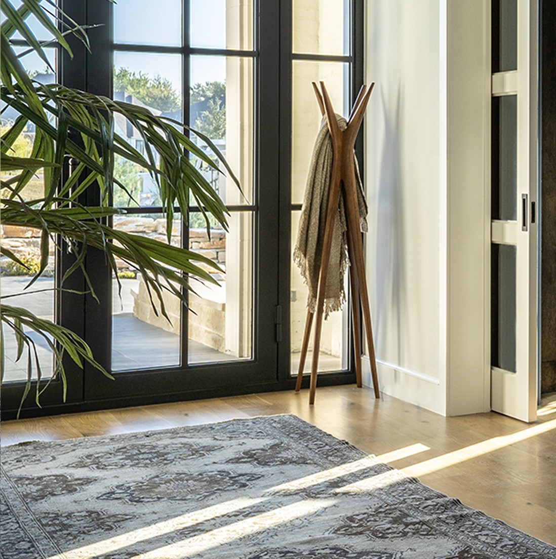 Luxurious copper-rimmed clawfoot bathtub with ornate feet in Fairview primary suite bathroom featuring geometric tile