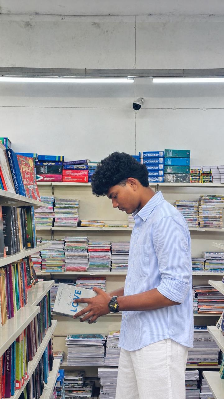 ASWINGHOSH browsing a bookshop