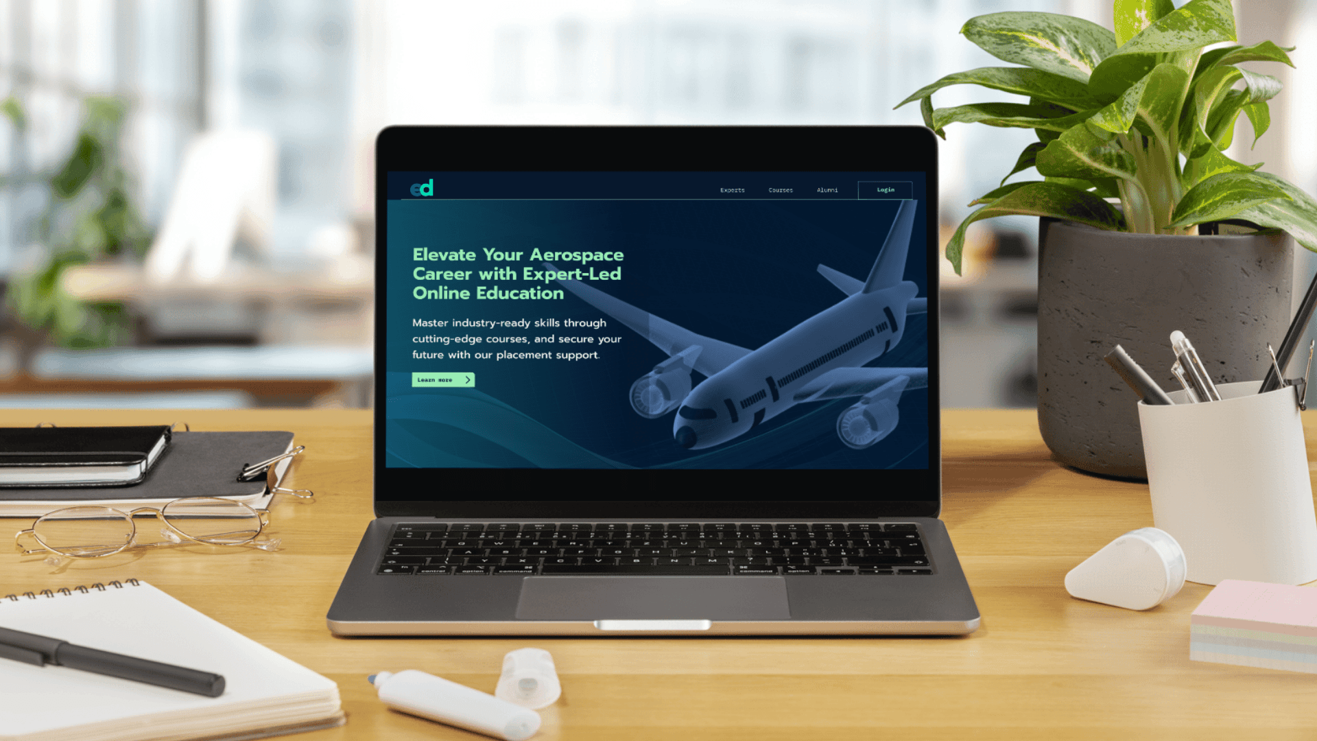 A mockup for a Macbook place on a table for an aerospace edtech website