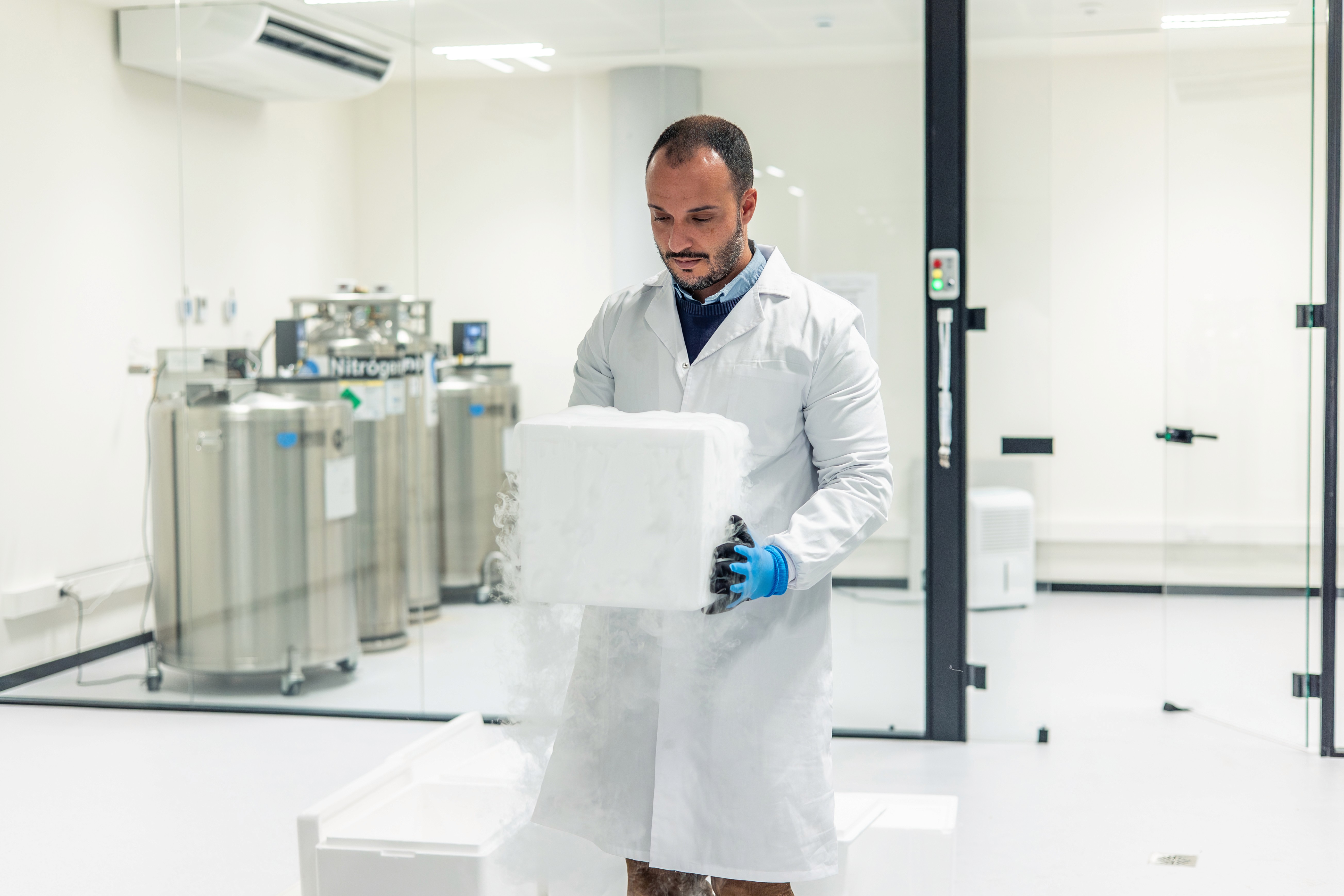Lab worker hold a cold-chain shipping box filled with sensitive materials