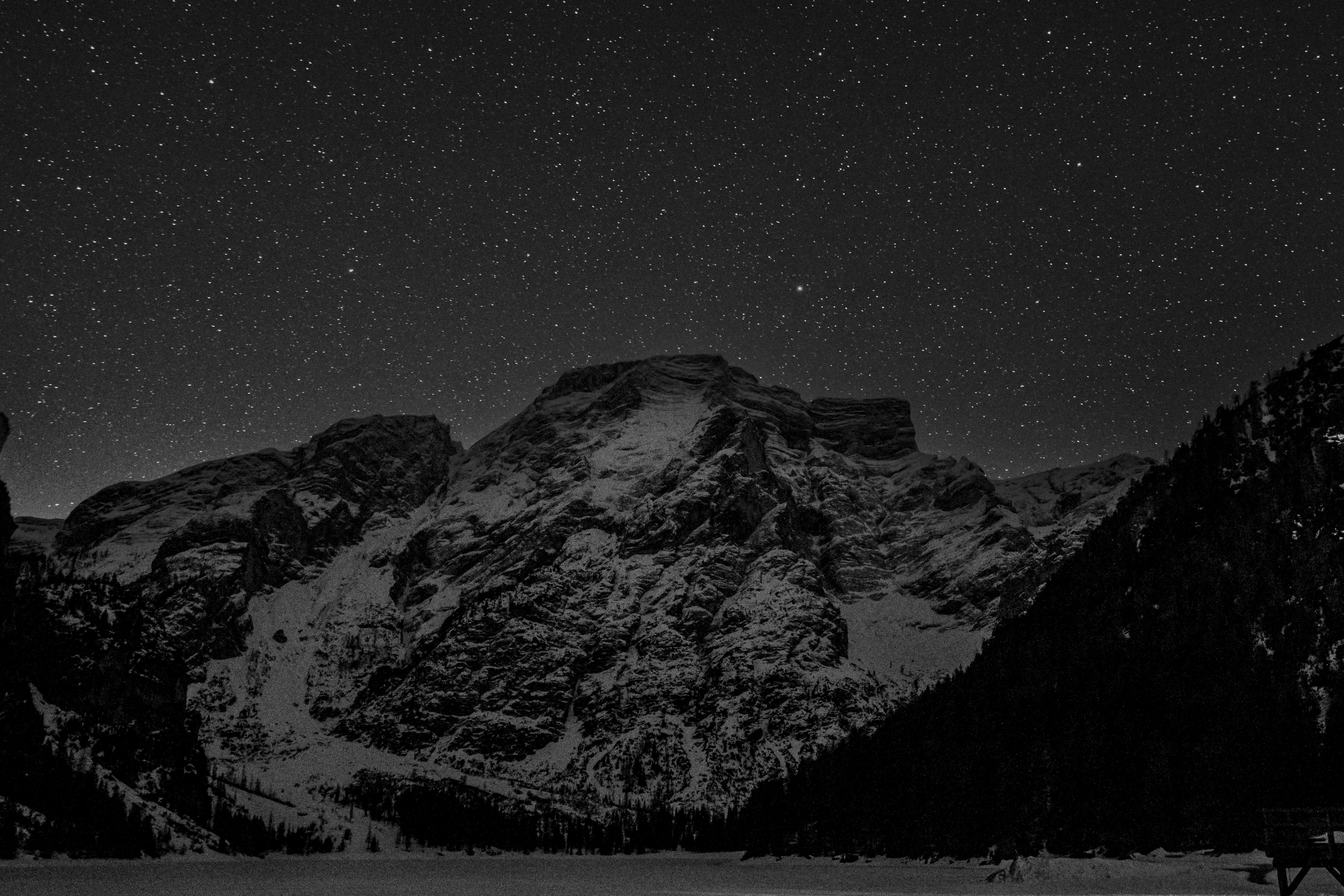 Snowy mountains under a starry night sky