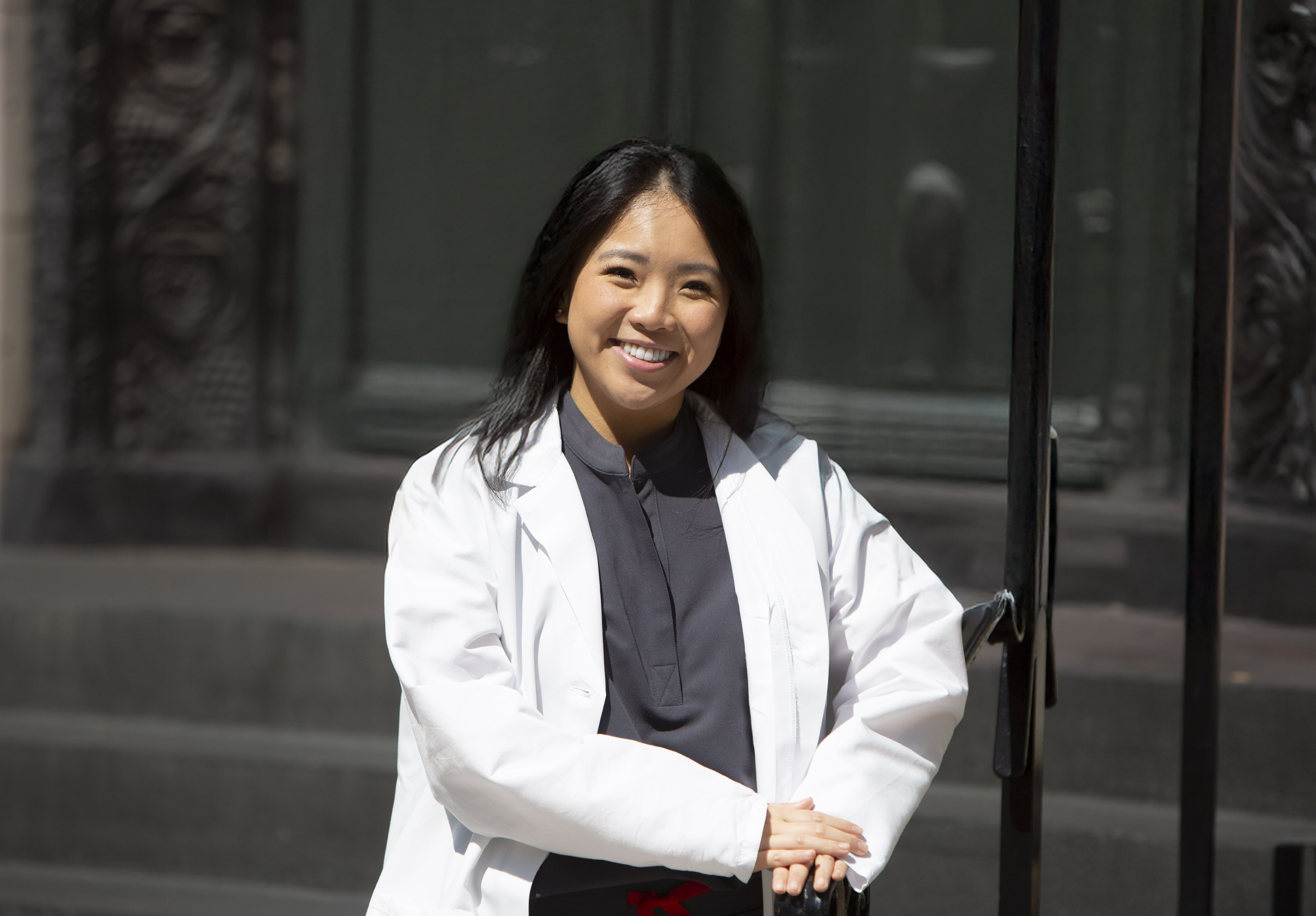 Portrait of a woman with long red hair gently touching her face, looking into the camera
