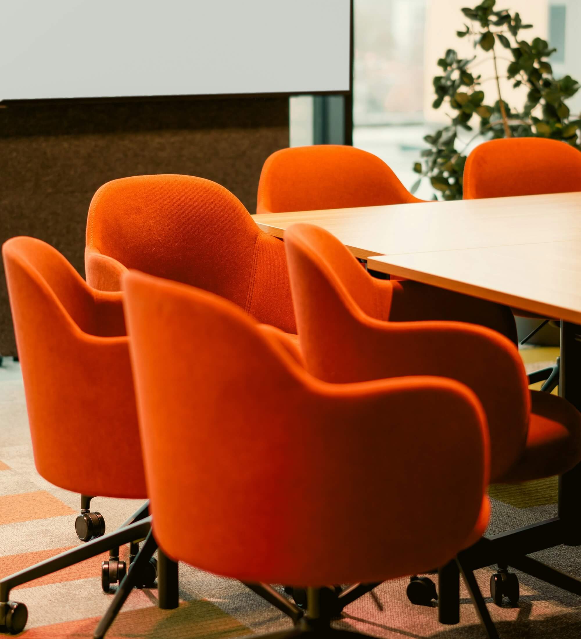 Orange chairs around a conference table - Boldway blog post on what a weak website signals to investors