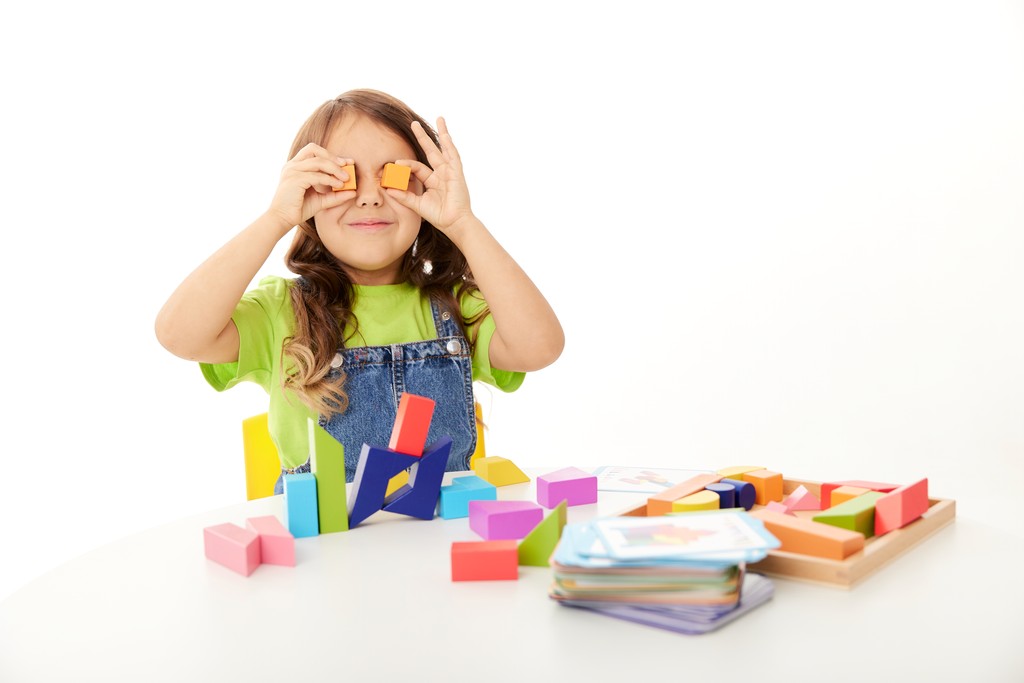 A girl playing with colourful play blocks