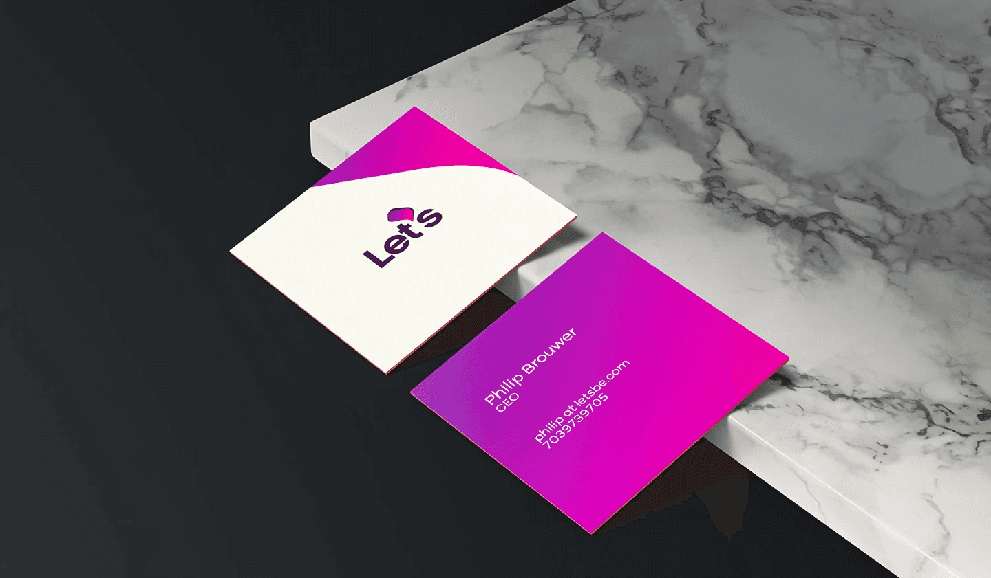 Graphic mockup of business cards on granite tiles.