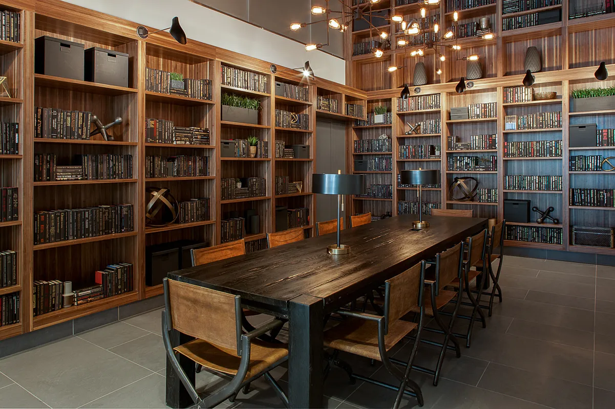 An inviting library with wooden tables and chairs, providing a comfortable environment for learning and reading.