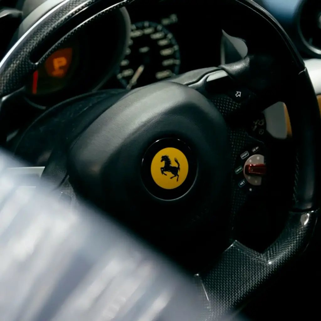 Ferrari interior detail inside a luxury vehicle undergoing auto body repair.