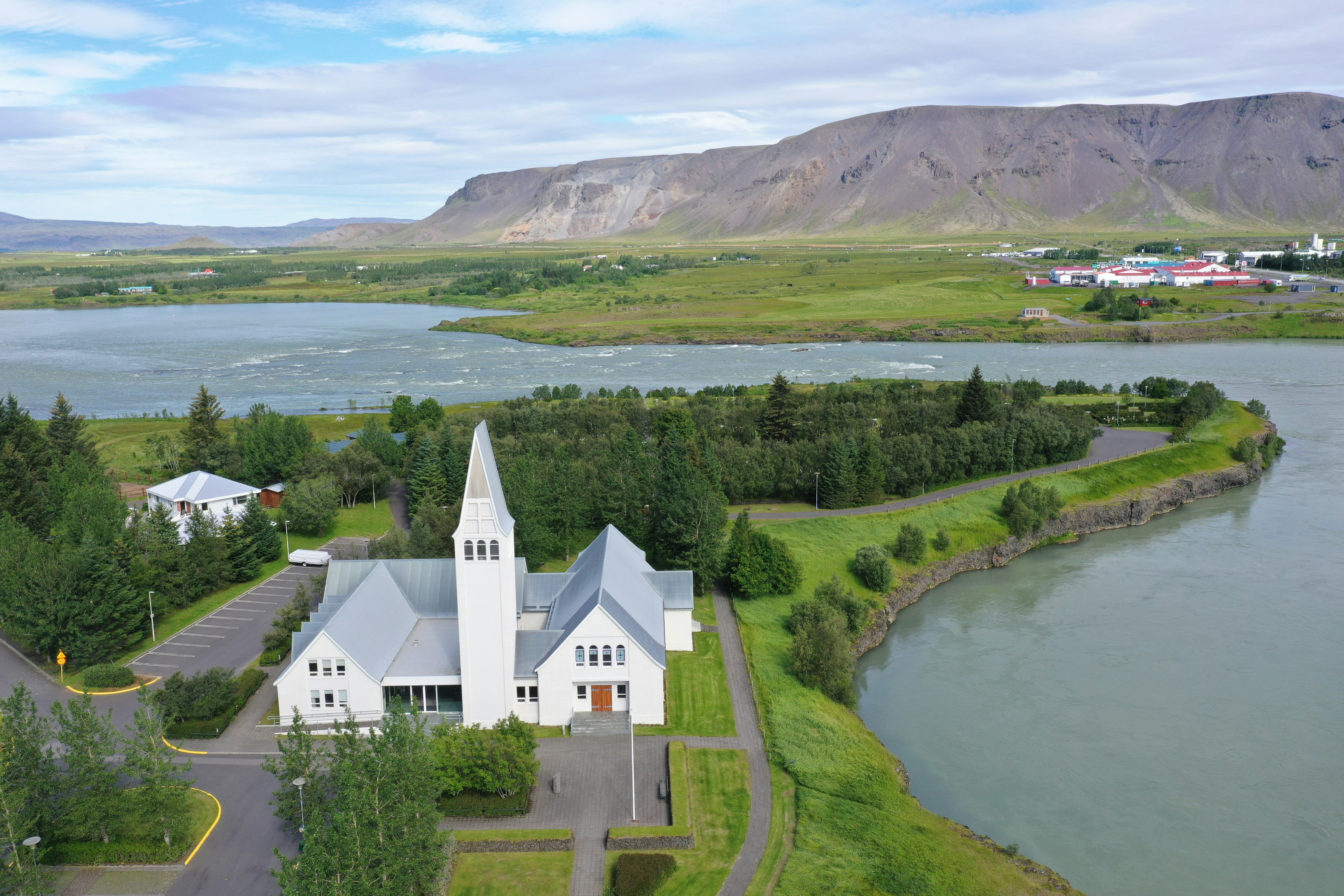 White Selfosskirkja Church along the riverbank in Selfoss, Iceland.