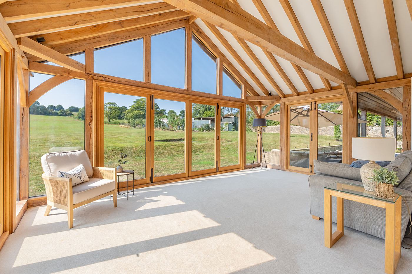 Garden room with full-height glazing overlooking fields