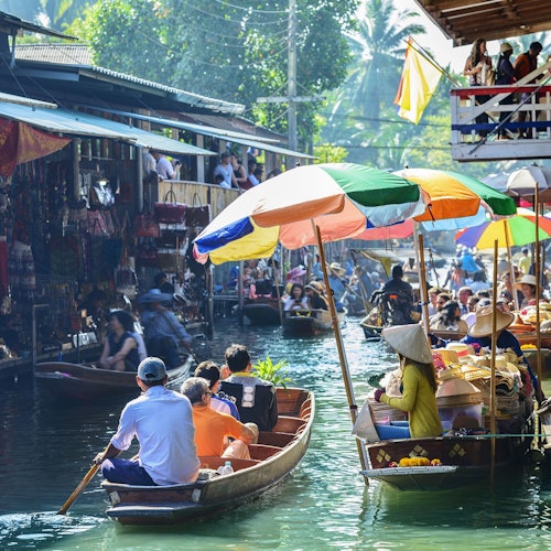 Explore the largest floating market in Thailand on a paddle boat.