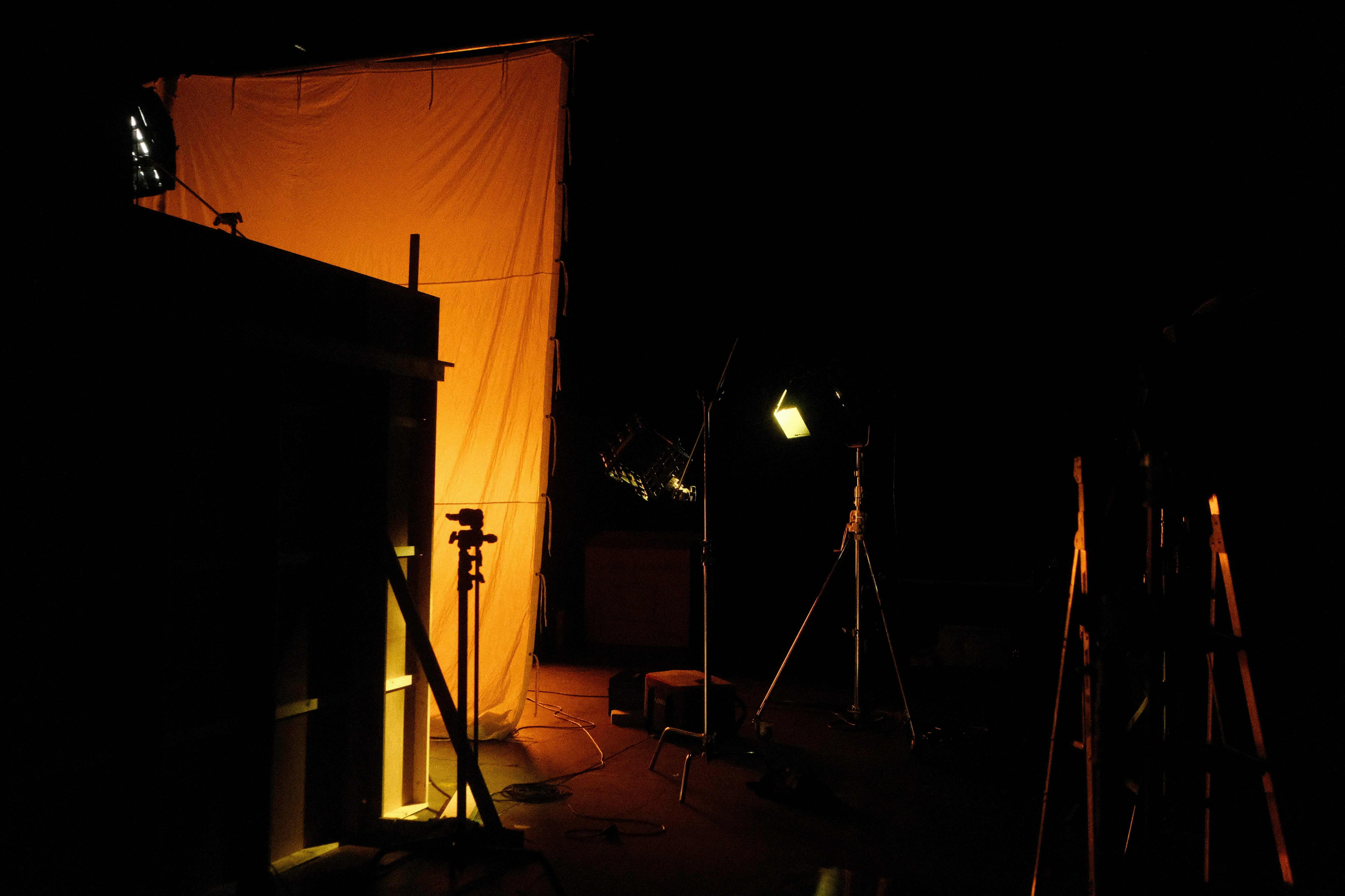 a dark room with lights and a curtain