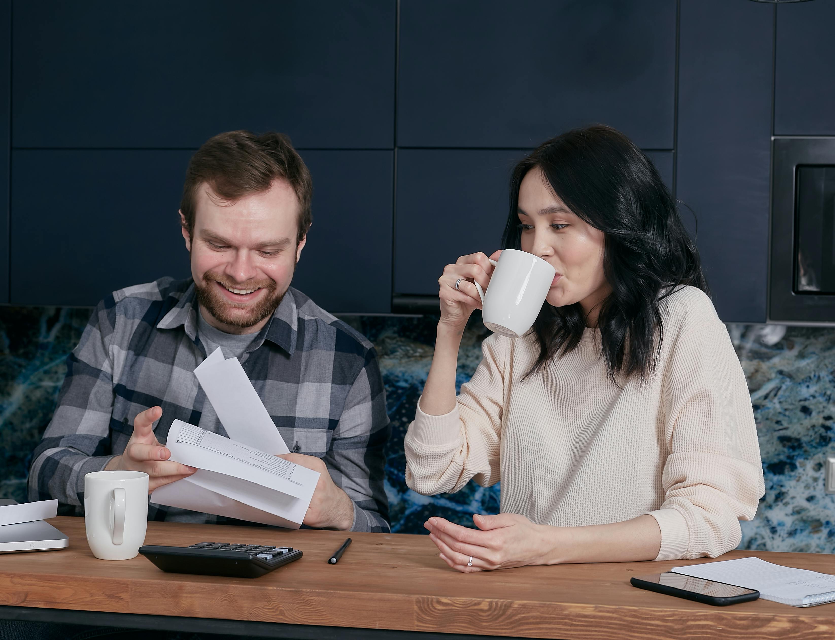 Couple sitting at the table going through paperwork
