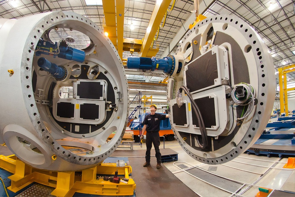 A photo of an industrial worker in a wind turbine manufacturing facility