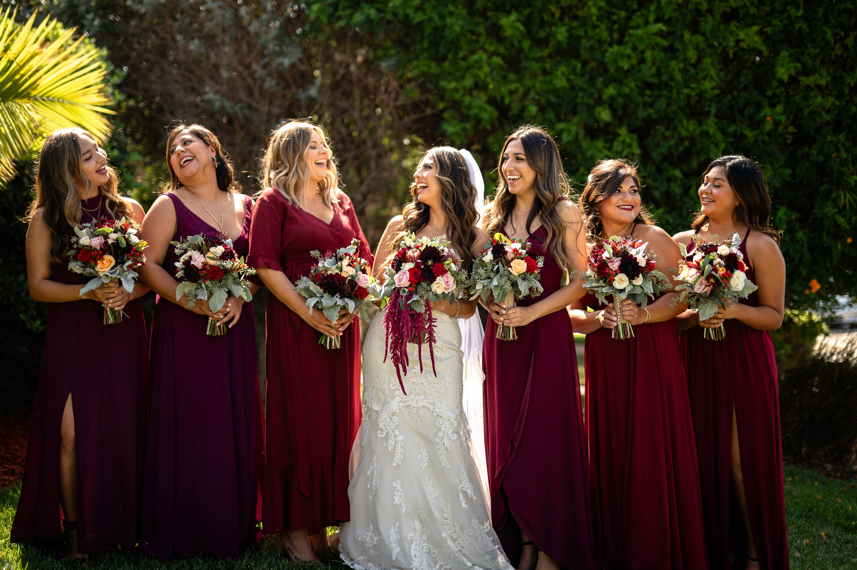 Bridesmaids group portrait on lawn before ceremony