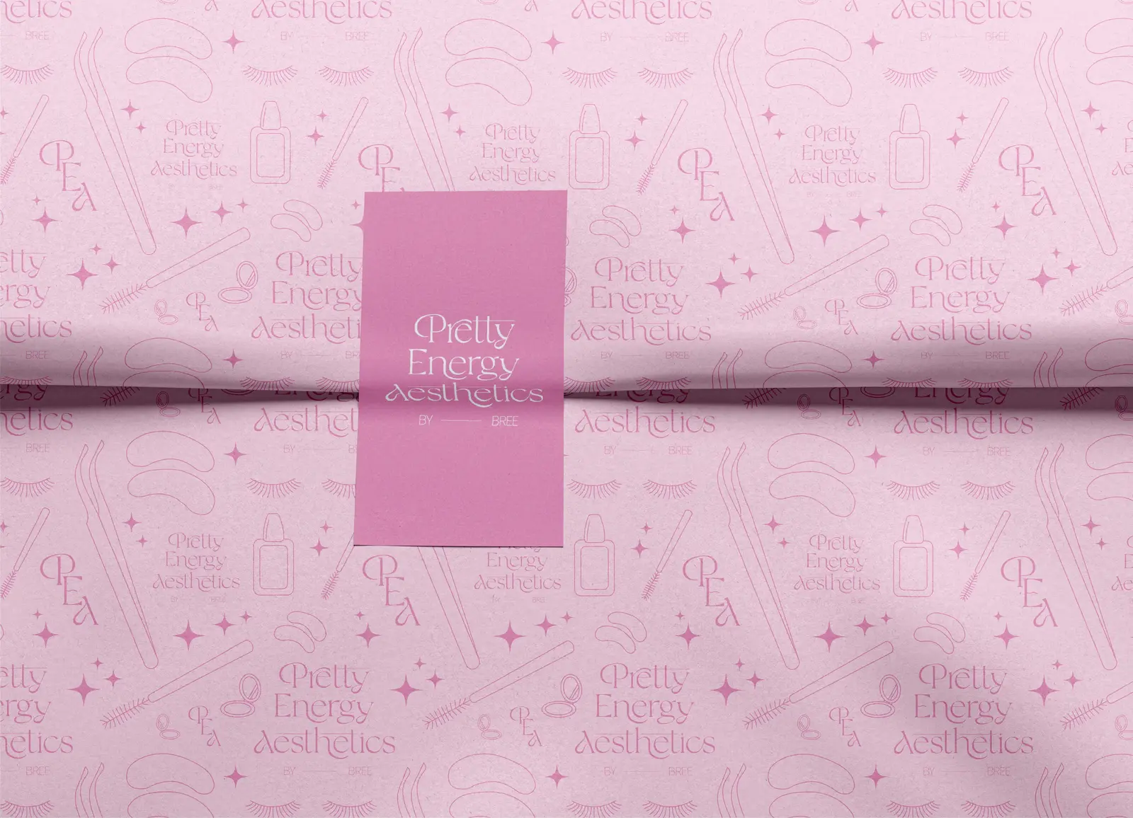 Pink Pretty Energy Aesthetics card on pink wrapping paper printed with beauty icons