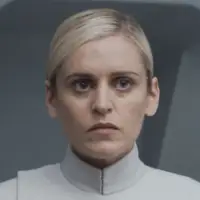 Denise Gough as Dedra Meero in a white unifrom