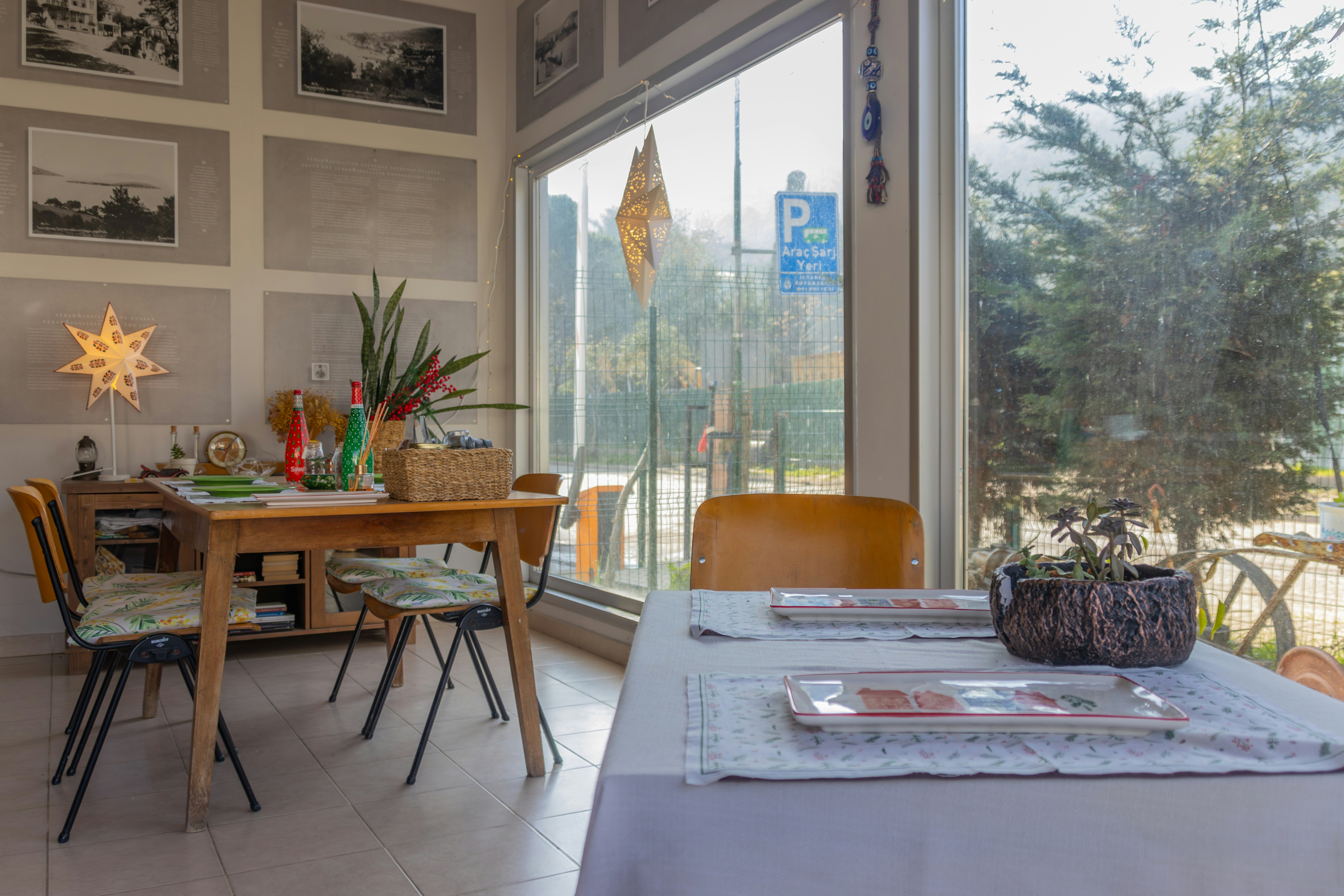 A dining room with a table, chairs, and pictures on the wall