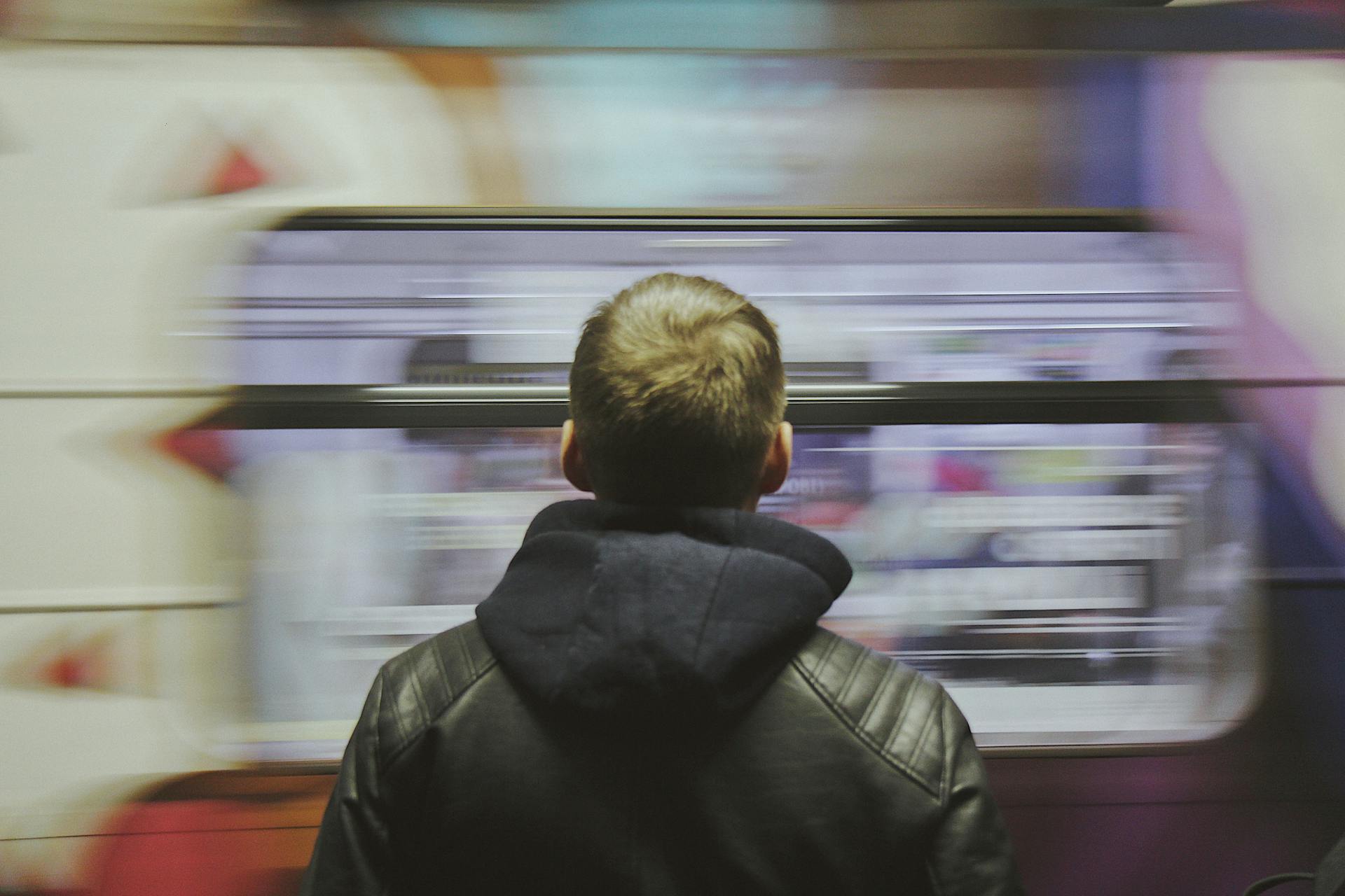 Metro Train behind Man in Leather Jacket