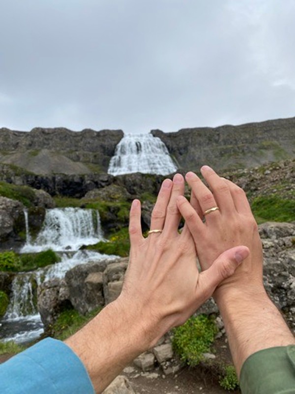 Matt Slow and Pavel Rat showing wedding rings at Dynjandi waterfall, Iceland