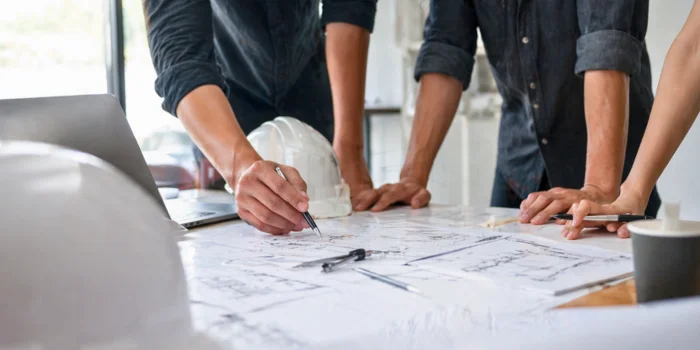 a man in a yellow shirt is working on a roof