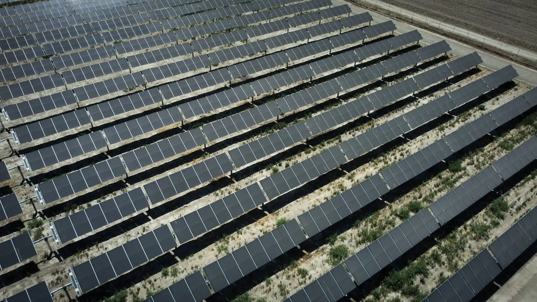 Drone view of utility-scale ground-mount solar rows | Premier Solar Service, serving Fresno, CA