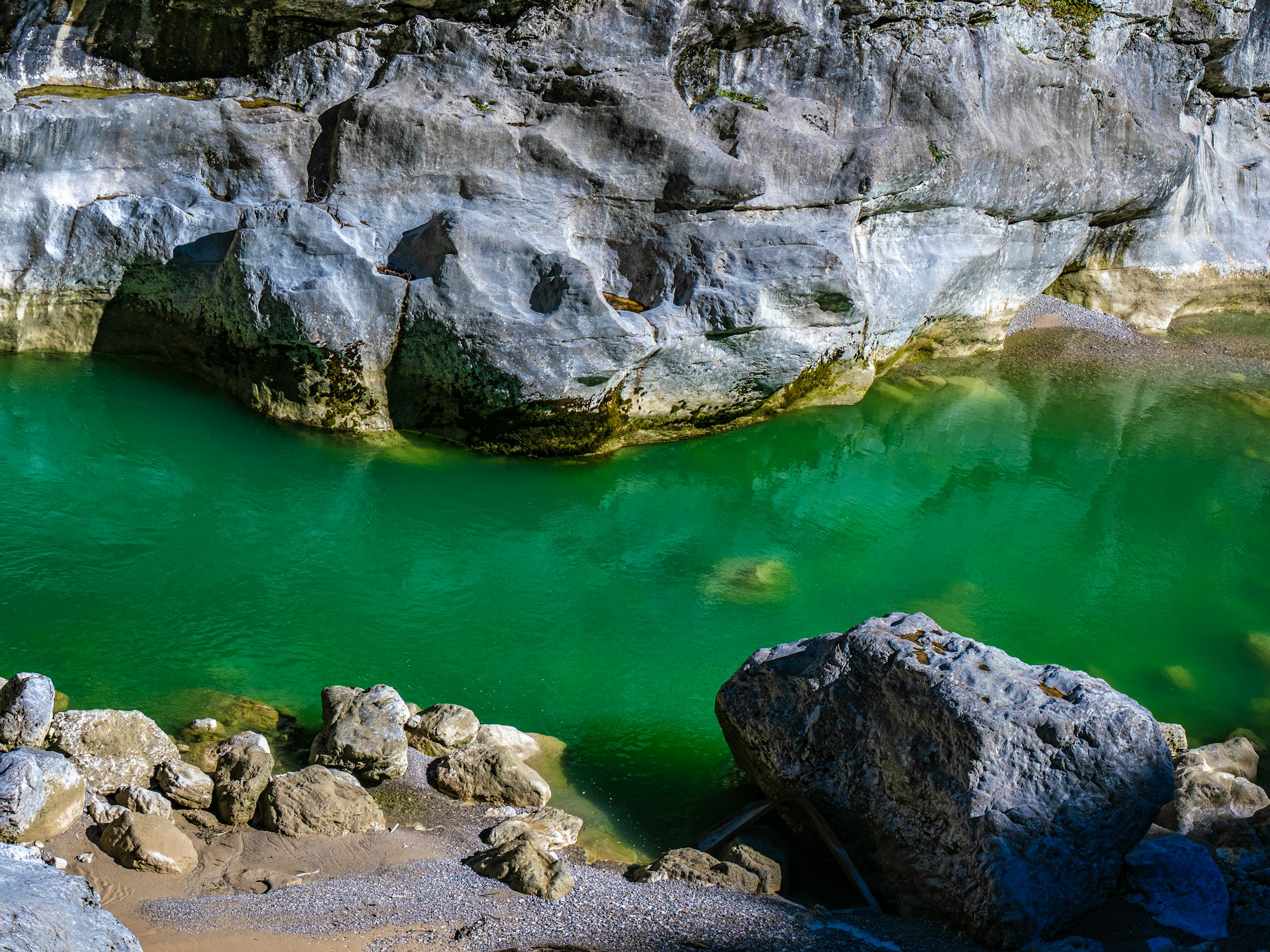 A green pool under the rocks