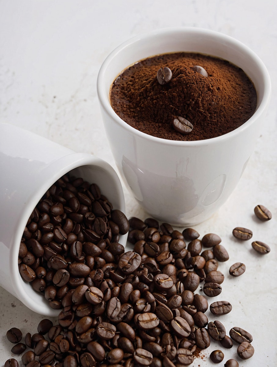 brown coffee beans on brown wooden chopping board