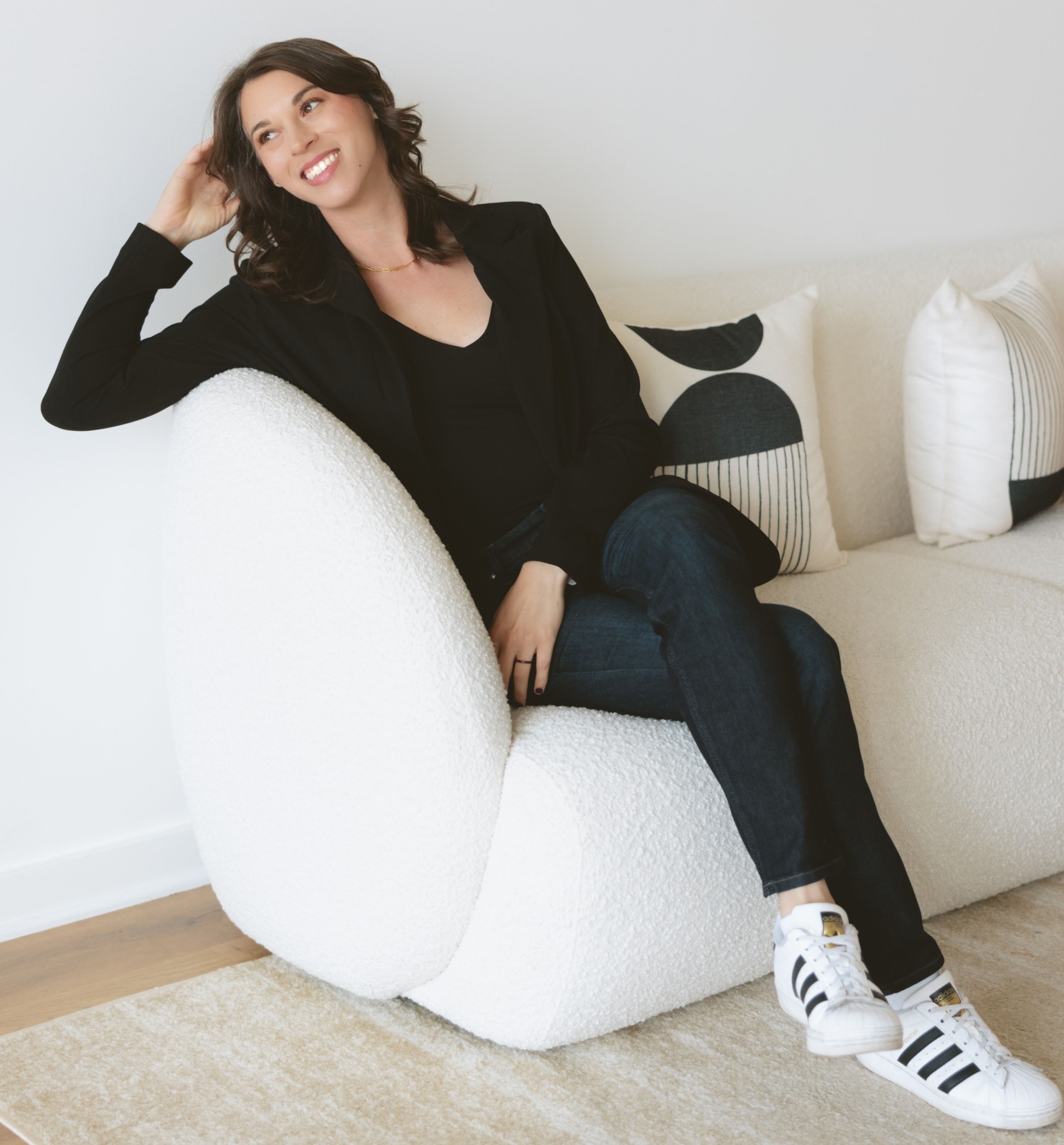 Image of Christine Sitting on a Couch Smiling