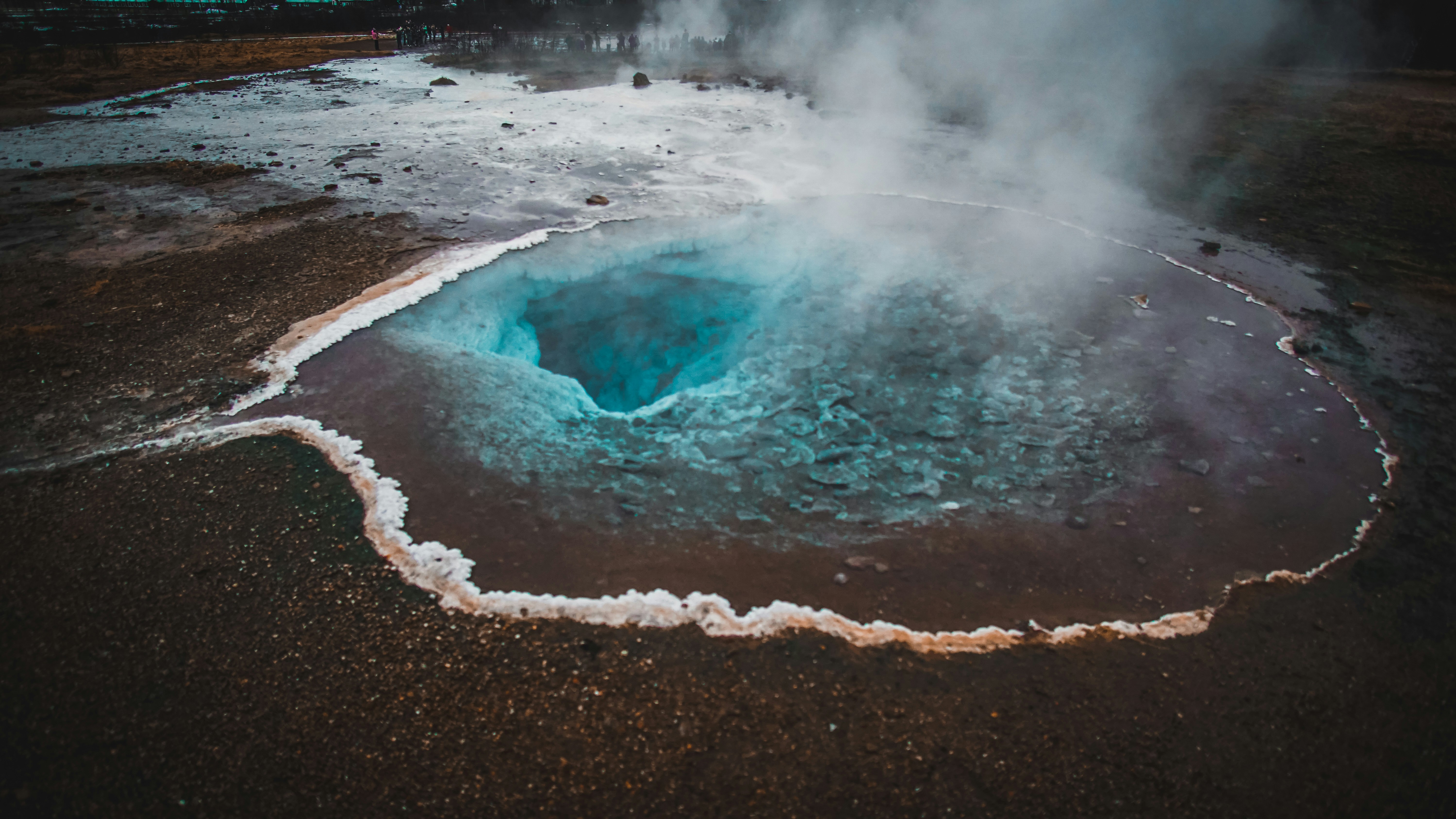a large crater with steam rising out of it