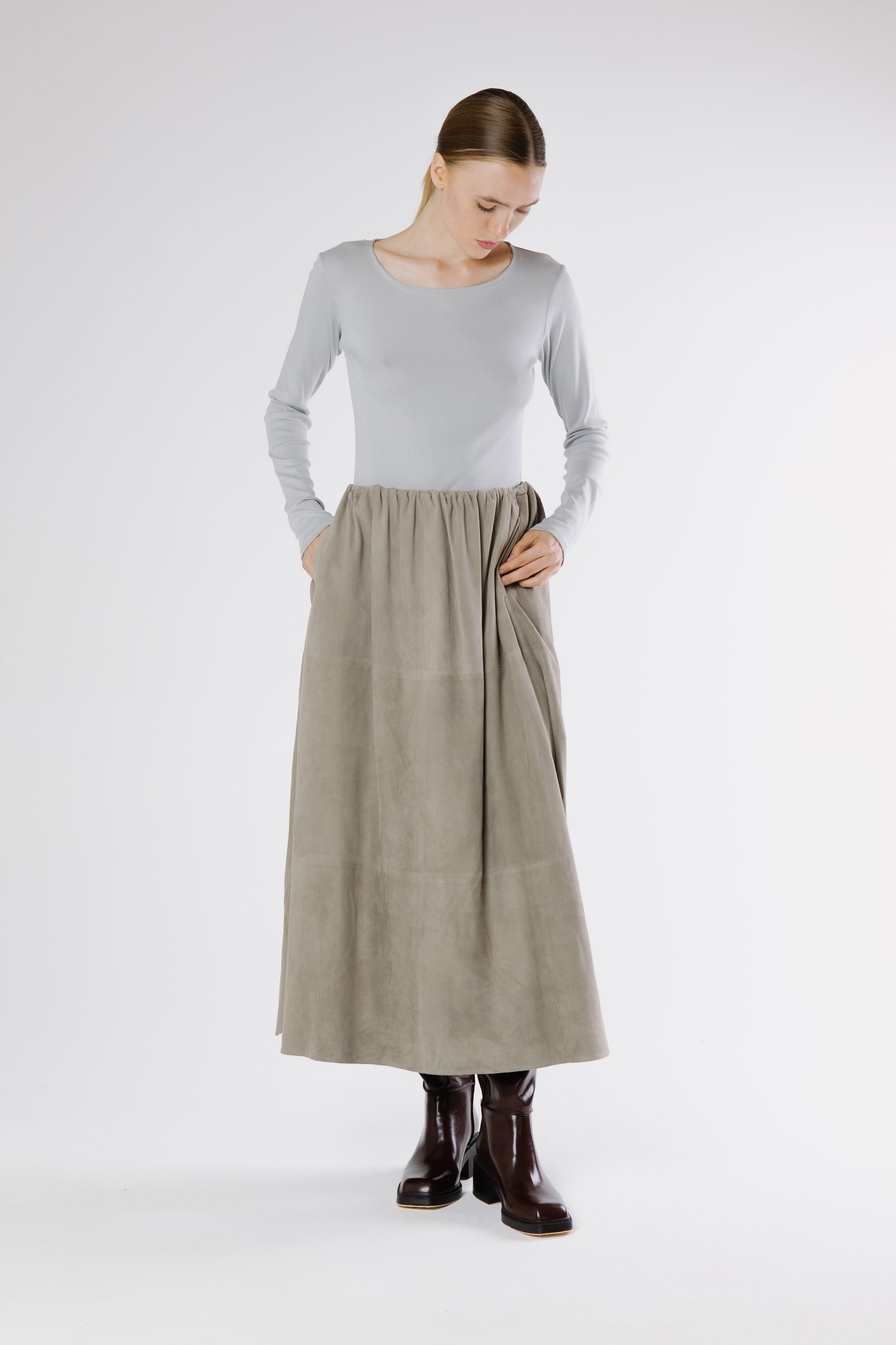 Drizzle grey suede maxi skirt styled with long sleeve top and leather boots, modern minimalist outfit