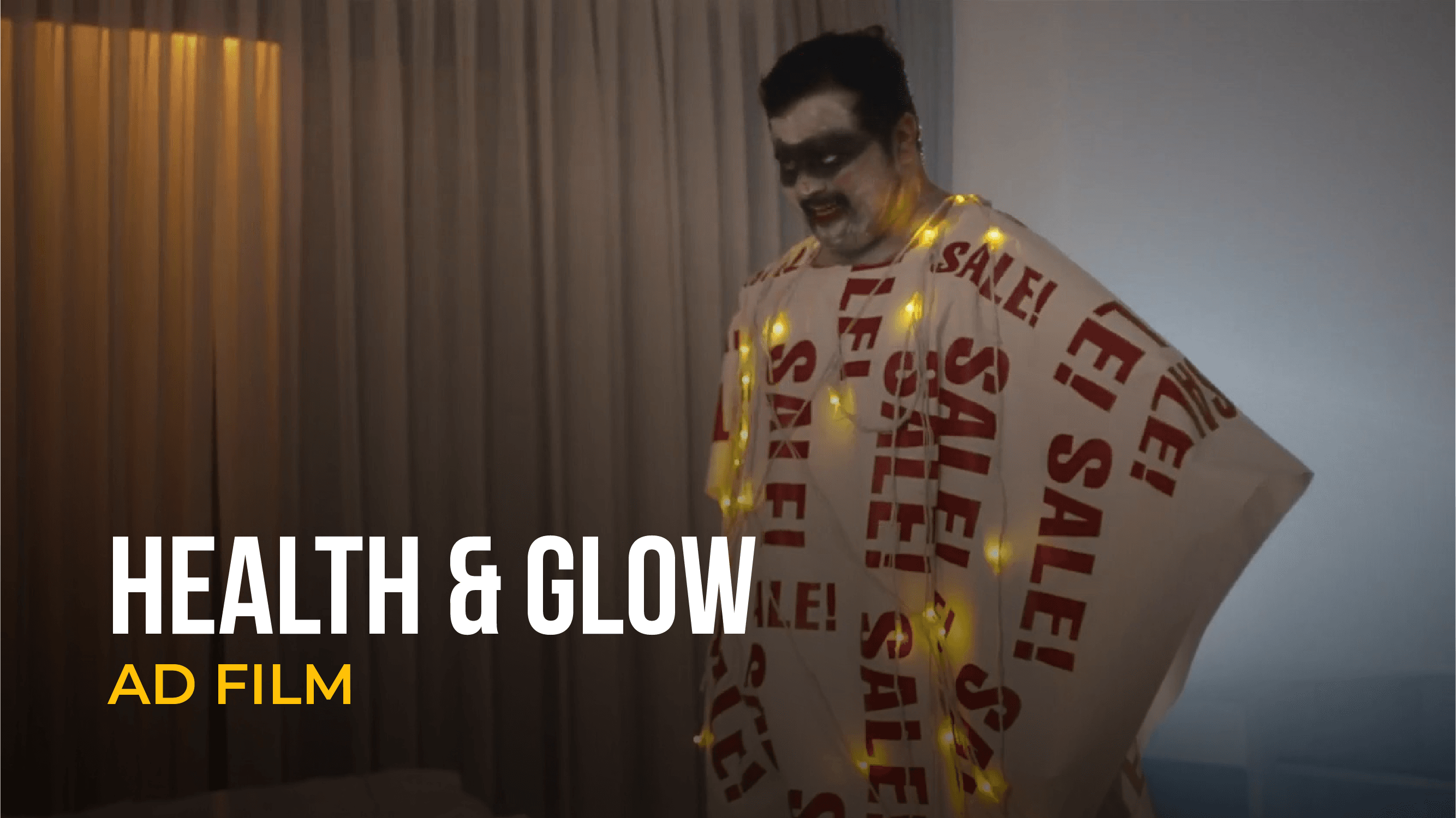 Man wrapped in sale banners featured in Health & Glow ad film.