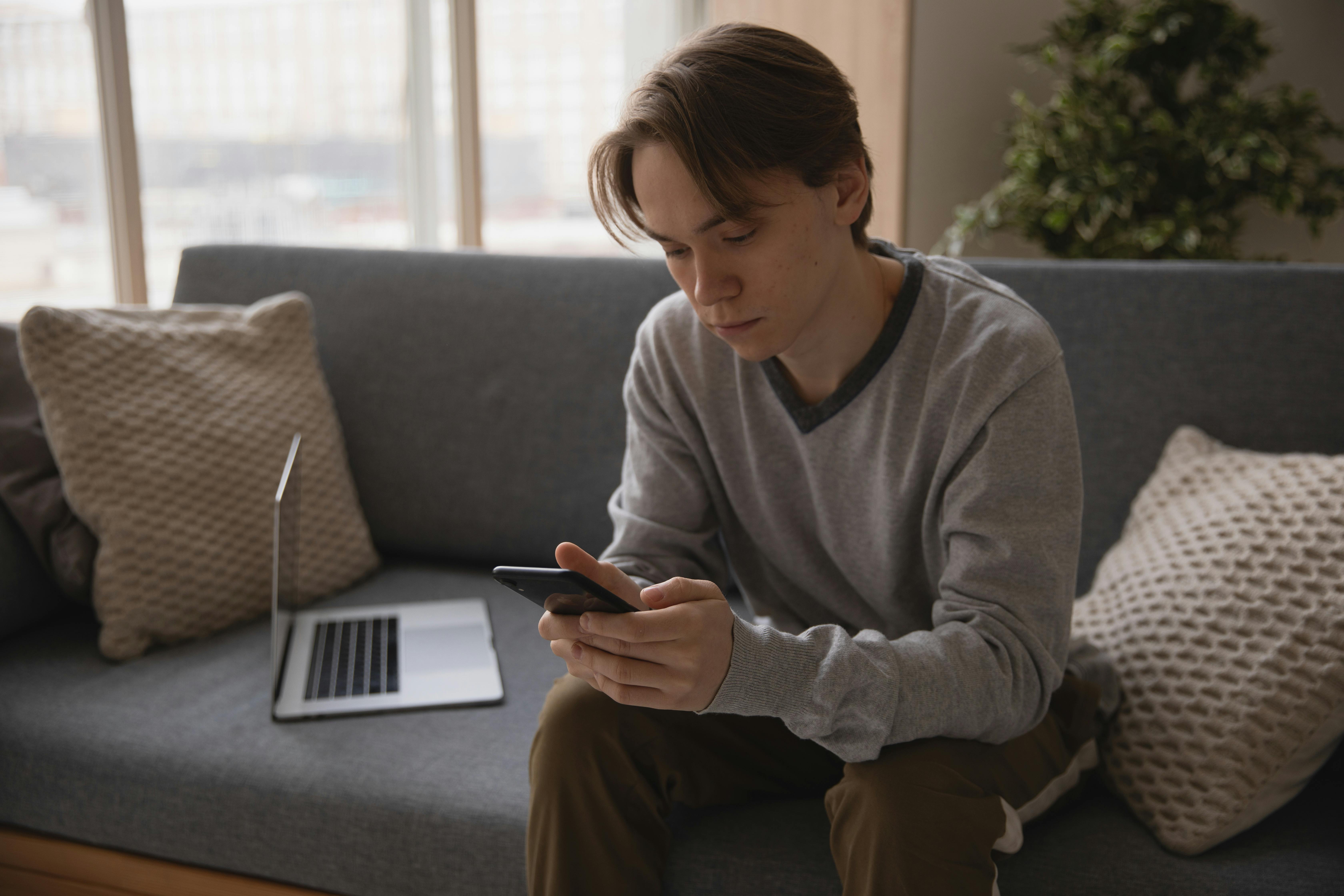 Man searching why cold emails fail using phone