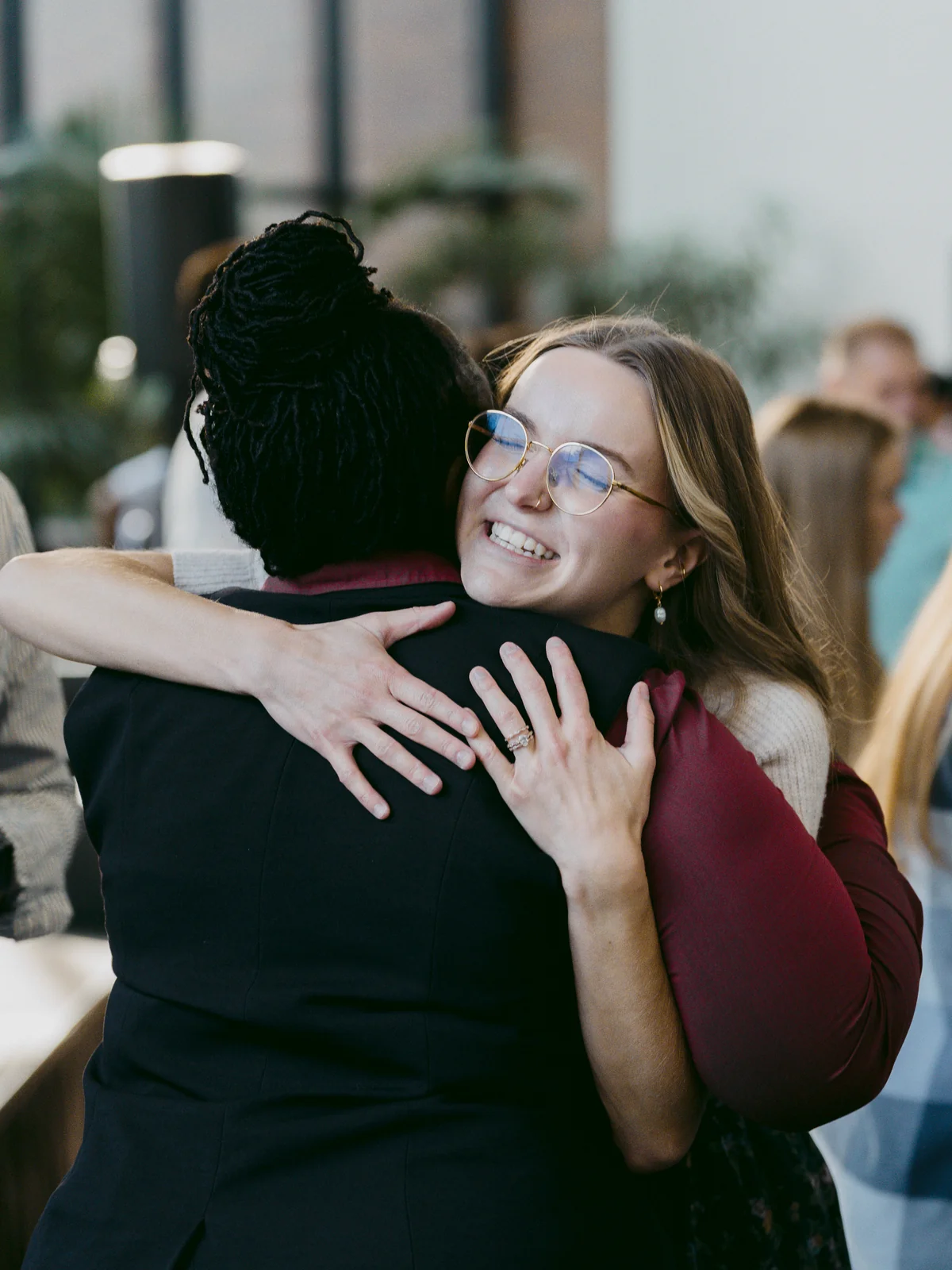 Two women sharing a joyful hug before service at Elan Church