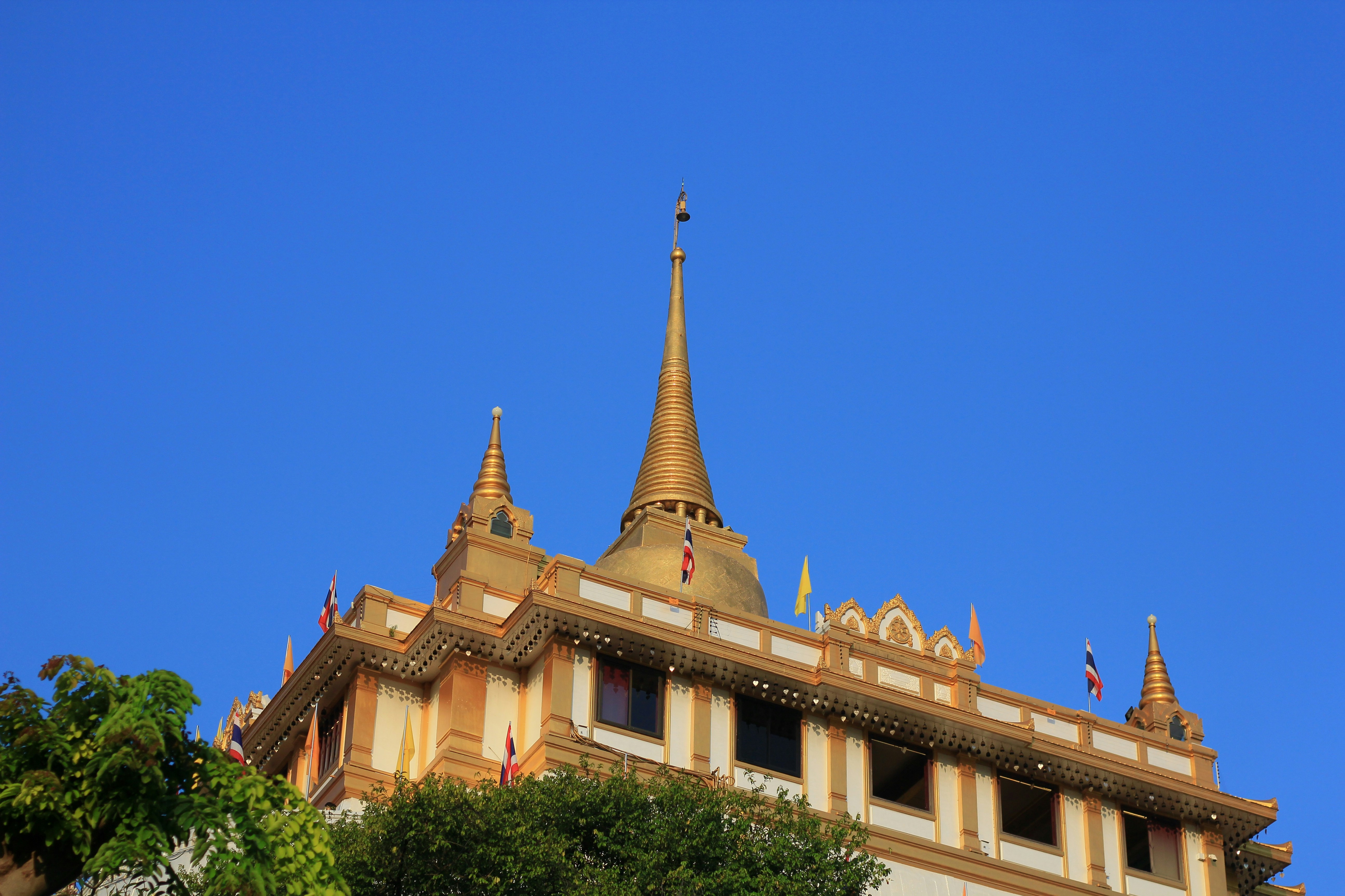 a tall building with a gold spire on top of it